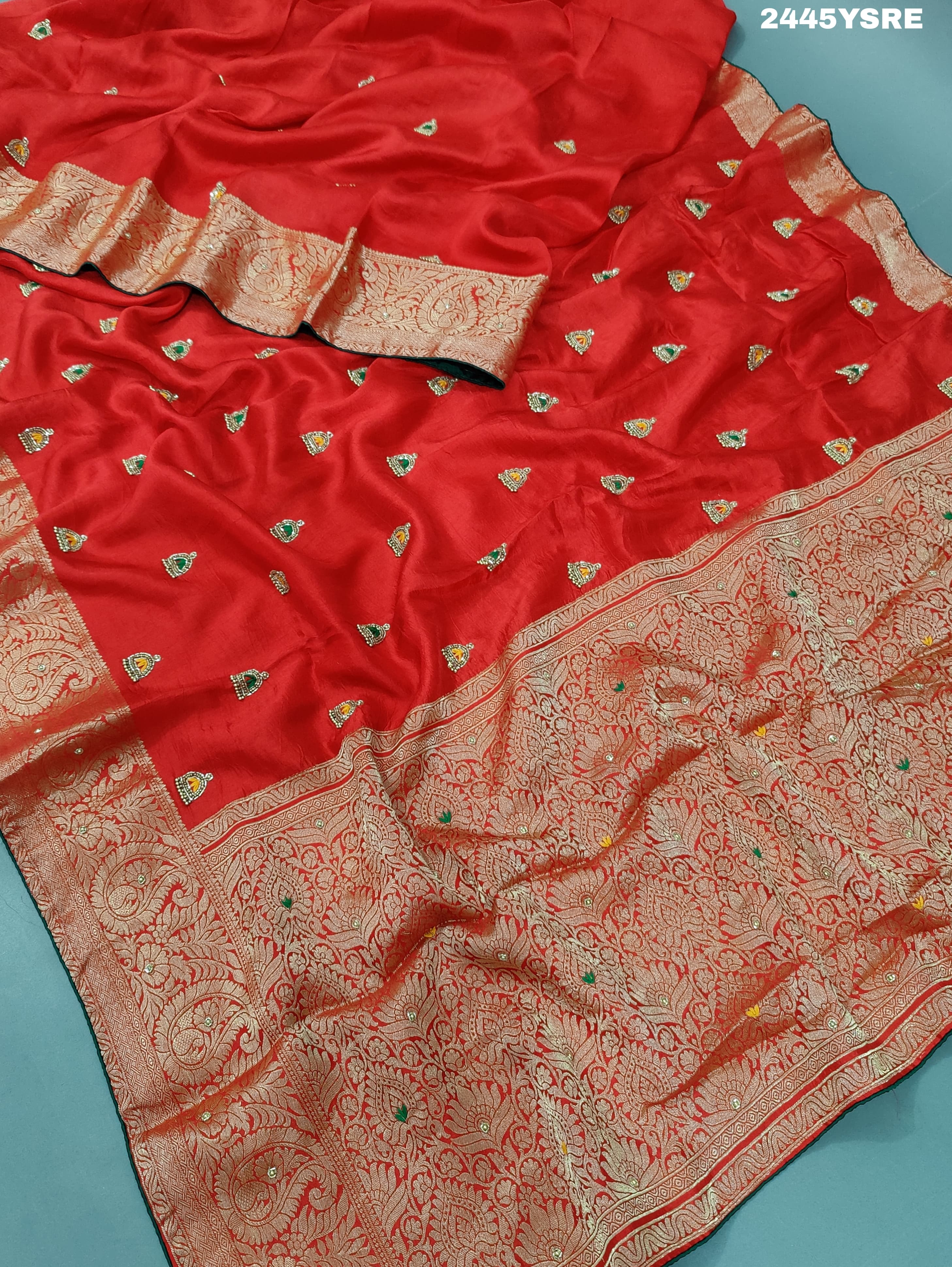 A red Banarasi silk saree with cutdana work and a golden border,