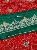 A red chiffon saree with bandhani pattern and gotapatti work