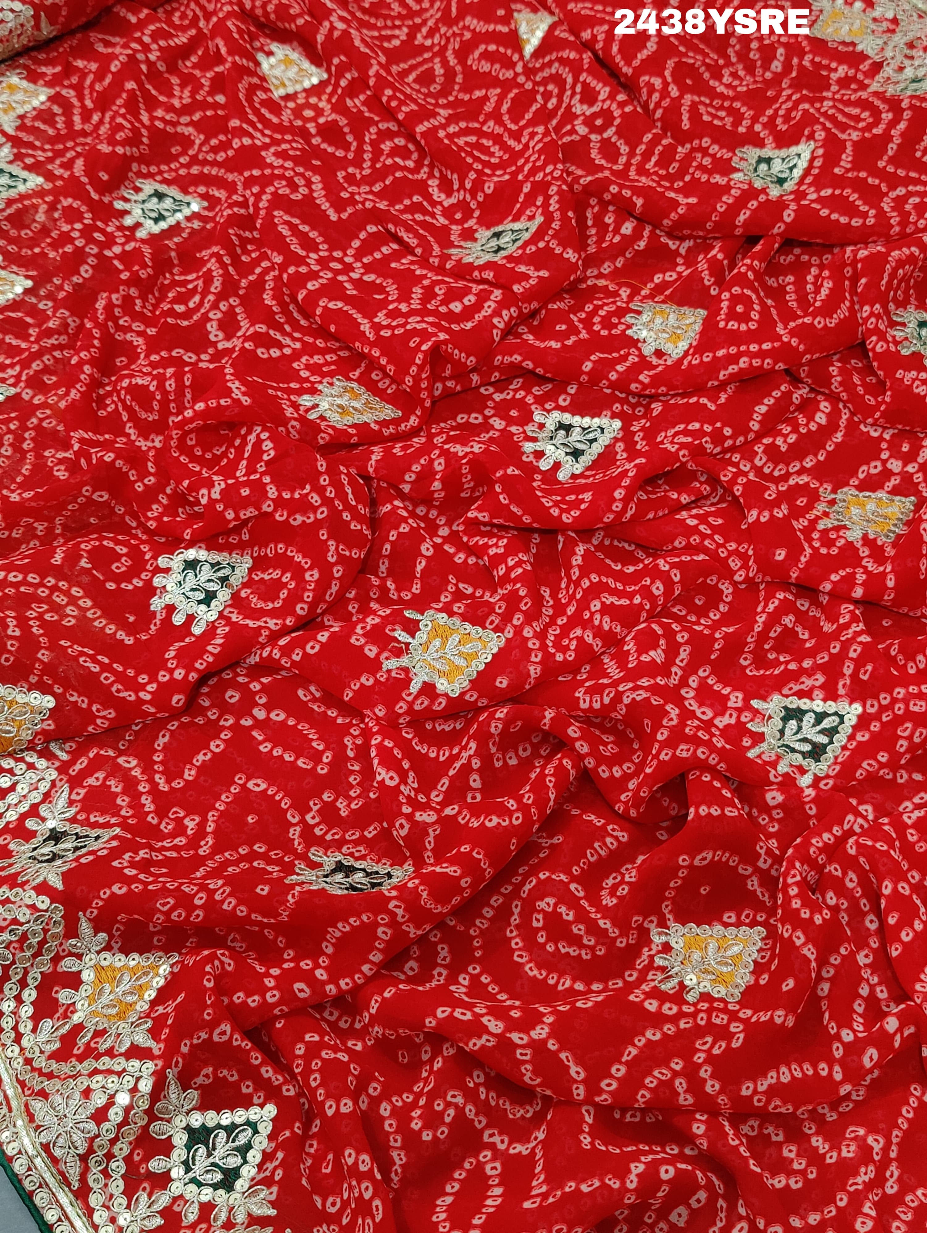 A red chiffon saree with bandhani pattern and gotapatti work