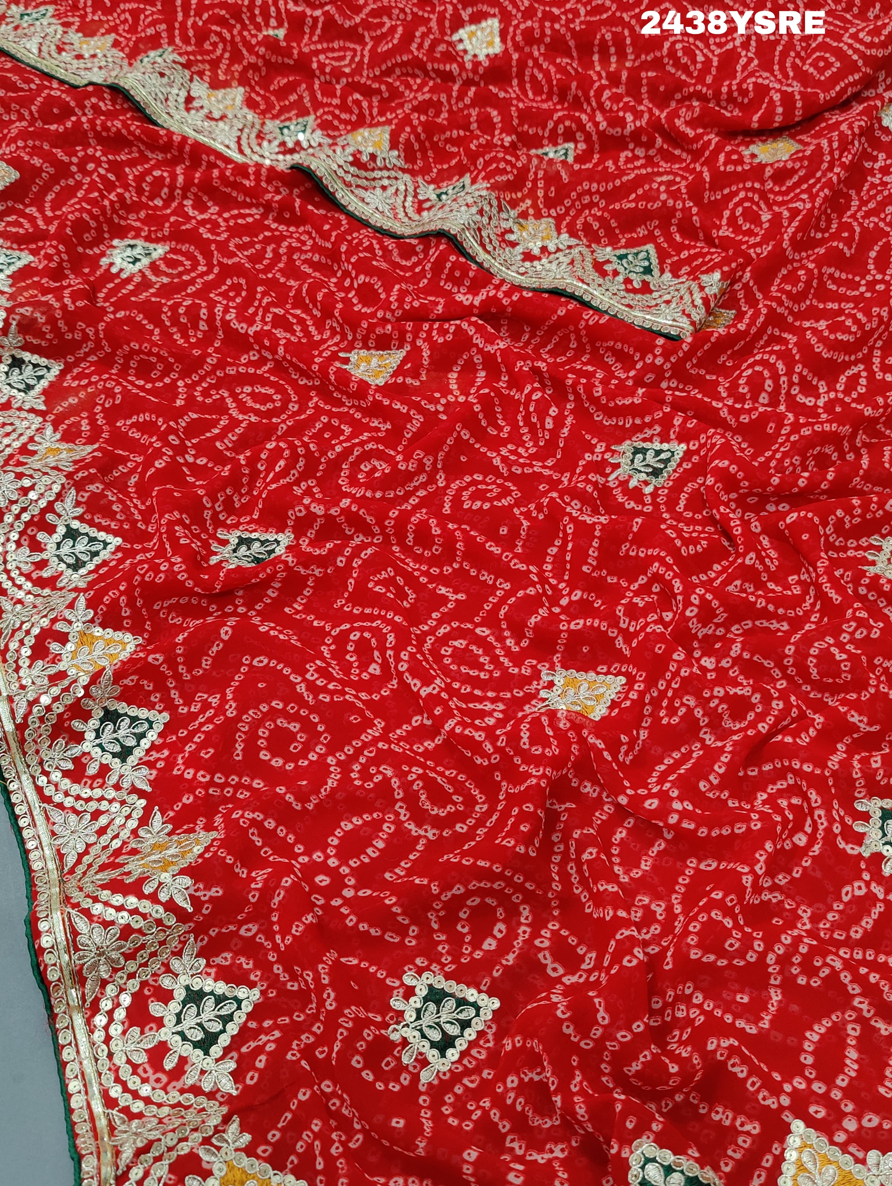 A red chiffon saree with bandhani pattern and gotapatti work