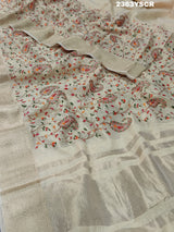 A cream-colored Kota Doriya saree with floral pattern