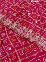 Apink saree with a bandhani pattern and gota patti work.