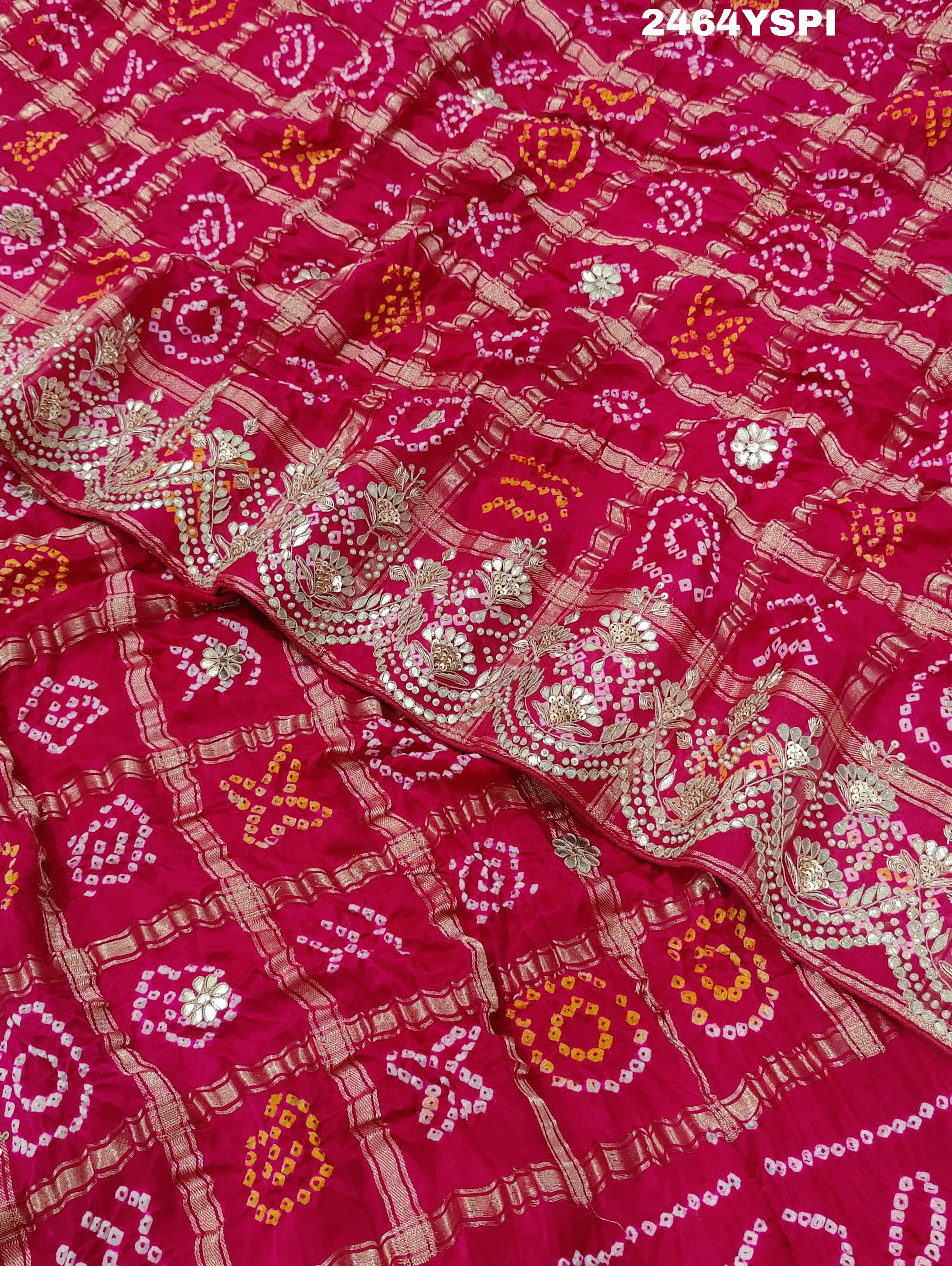 Apink saree with a bandhani pattern and gota patti work.