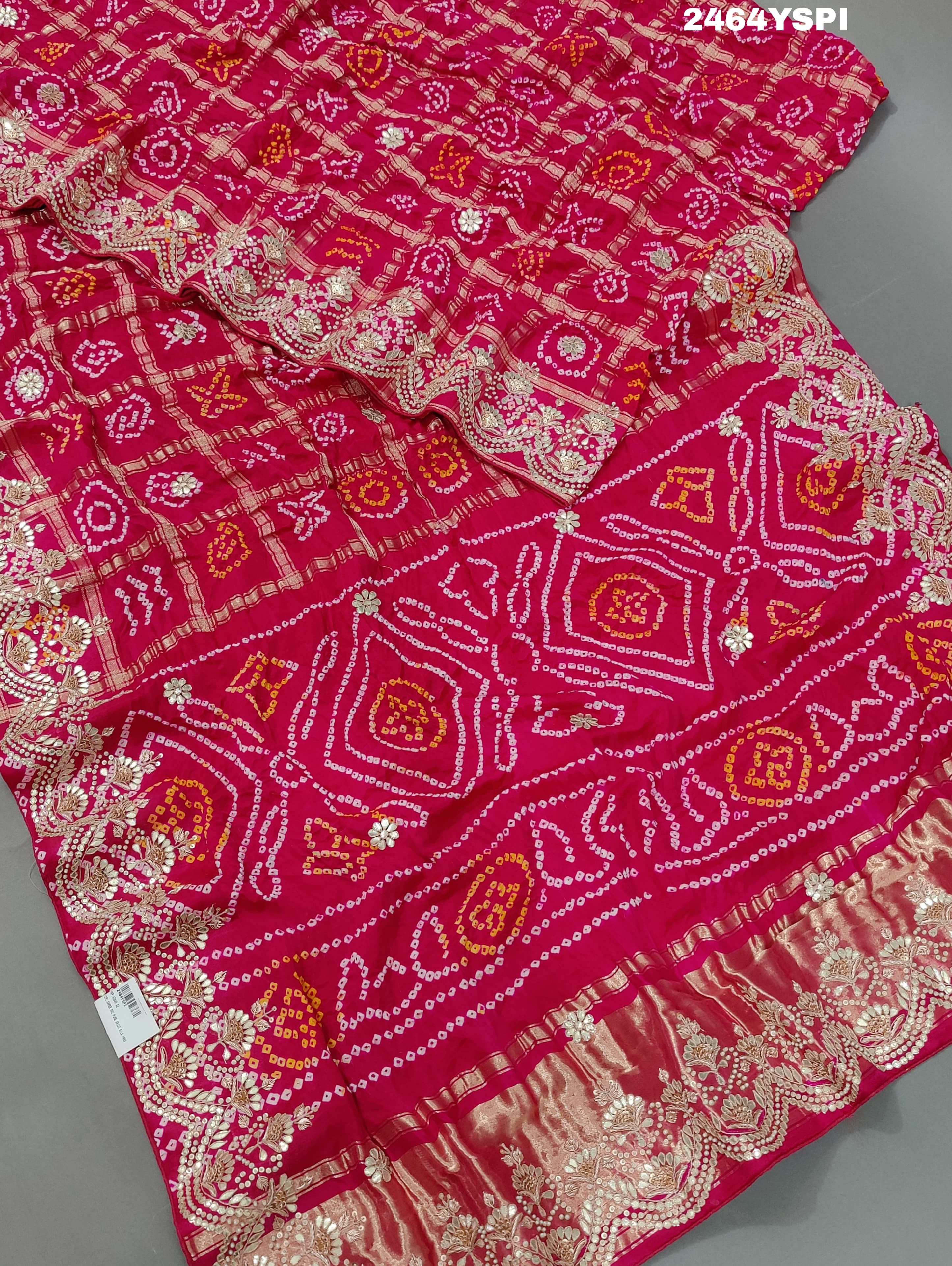 Apink saree with a bandhani pattern and gota patti work.