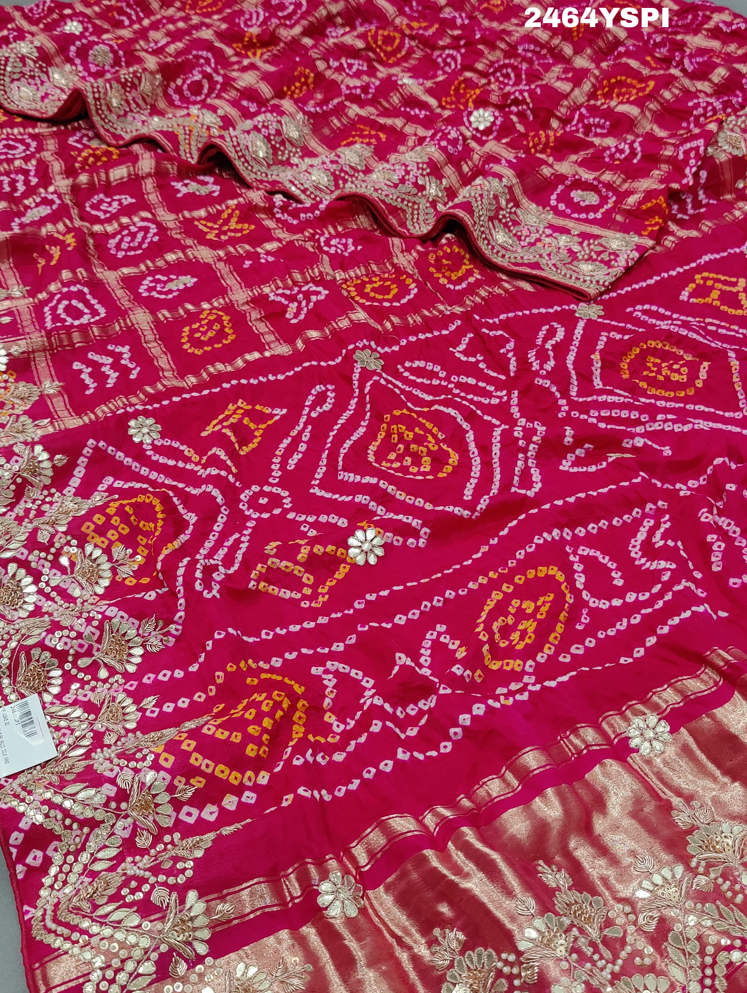 Apink saree with a bandhani pattern and gota patti work.