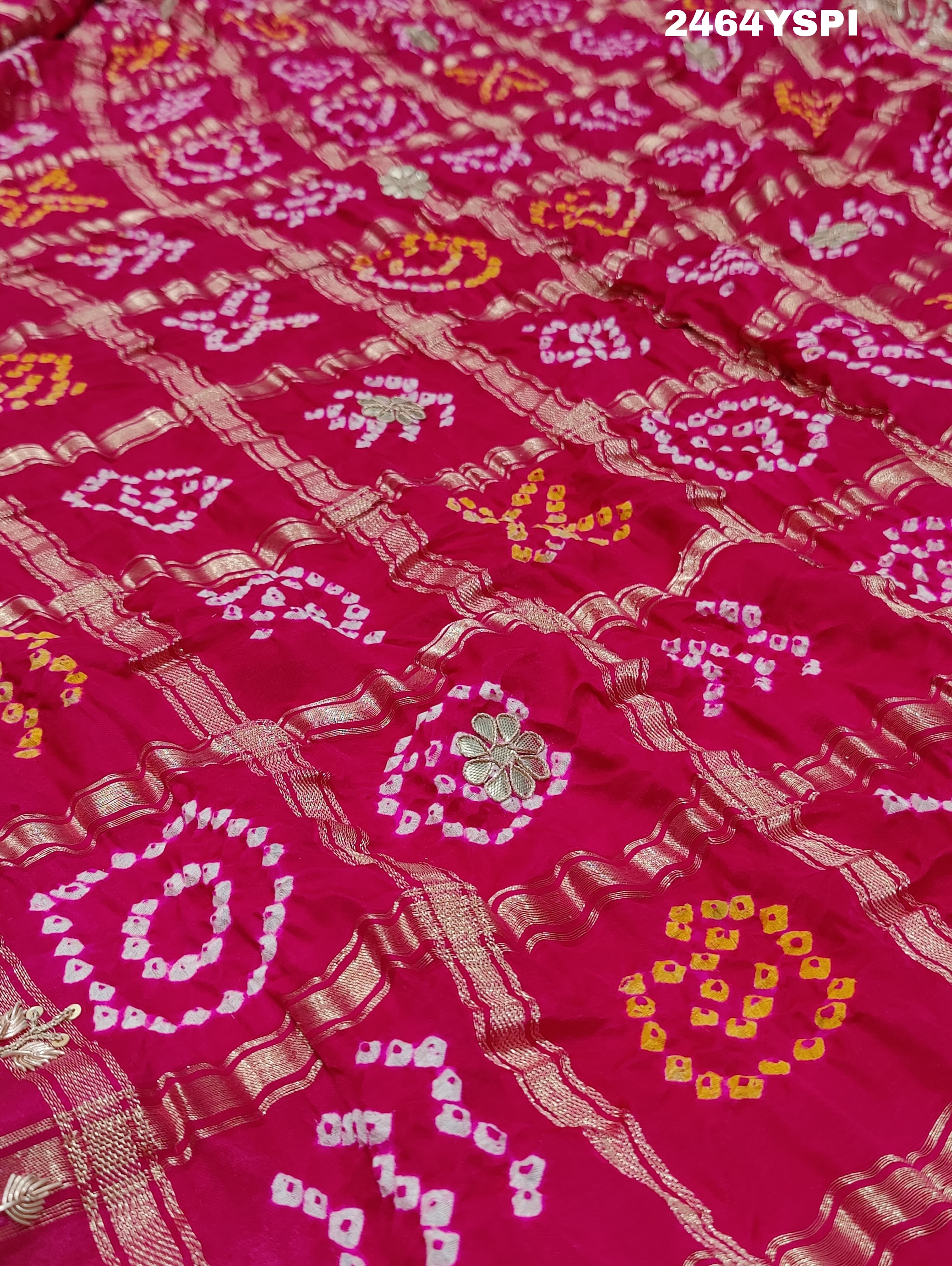 Apink saree with a bandhani pattern and gota patti work.