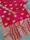 A pink Dola Silk Banarasi saree with Zari weaving work
