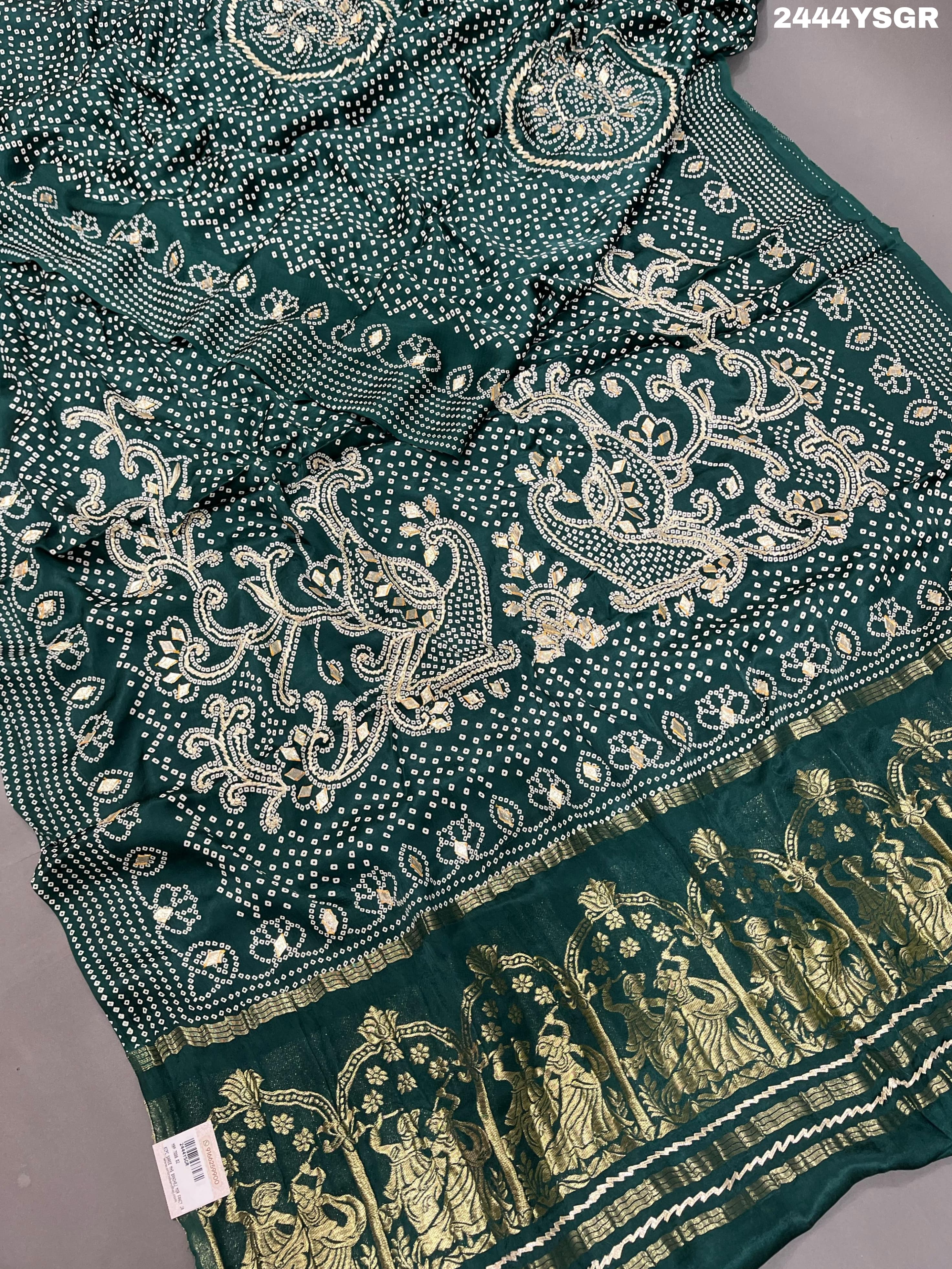 A green modal silk saree with bandhani style patterns and gotapatti work