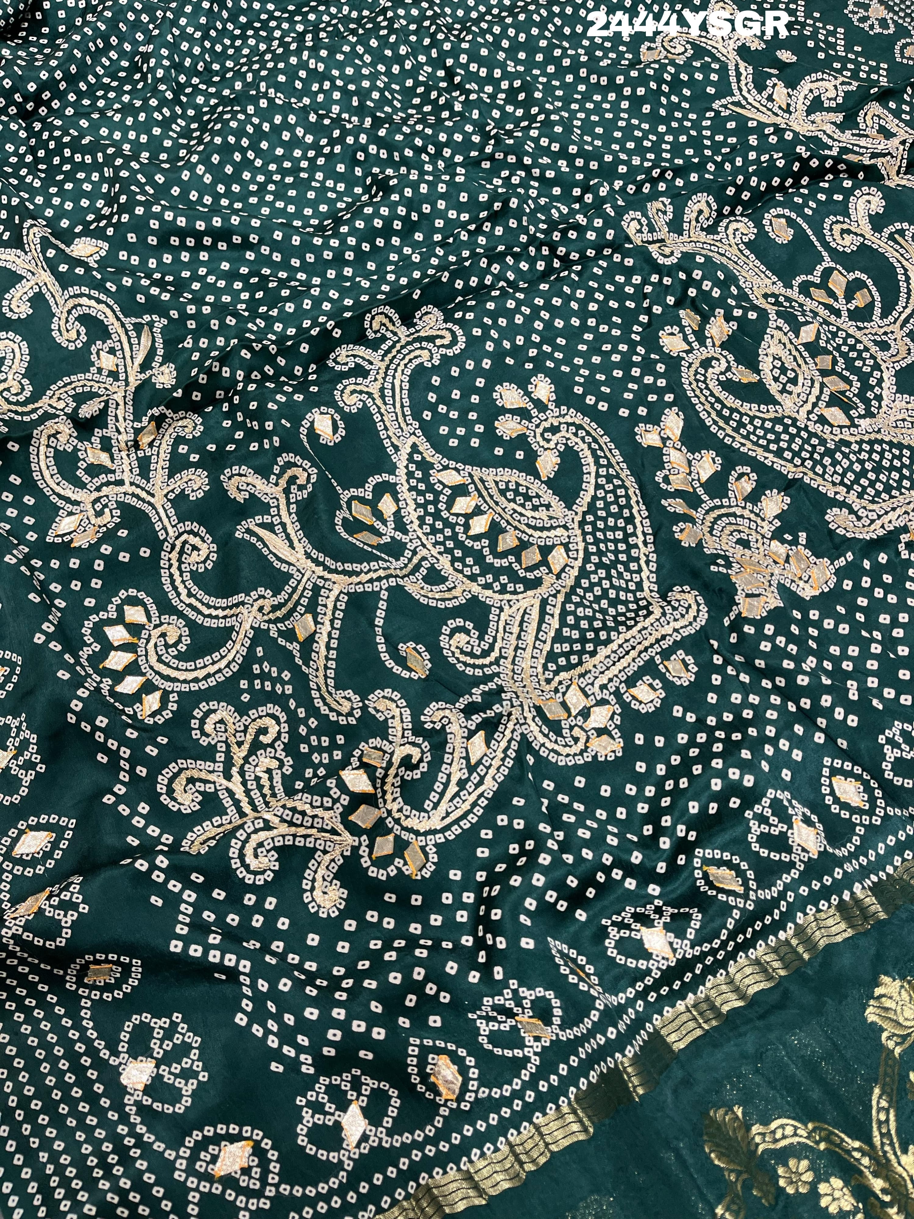 A green modal silk saree with bandhani style patterns and gotapatti work