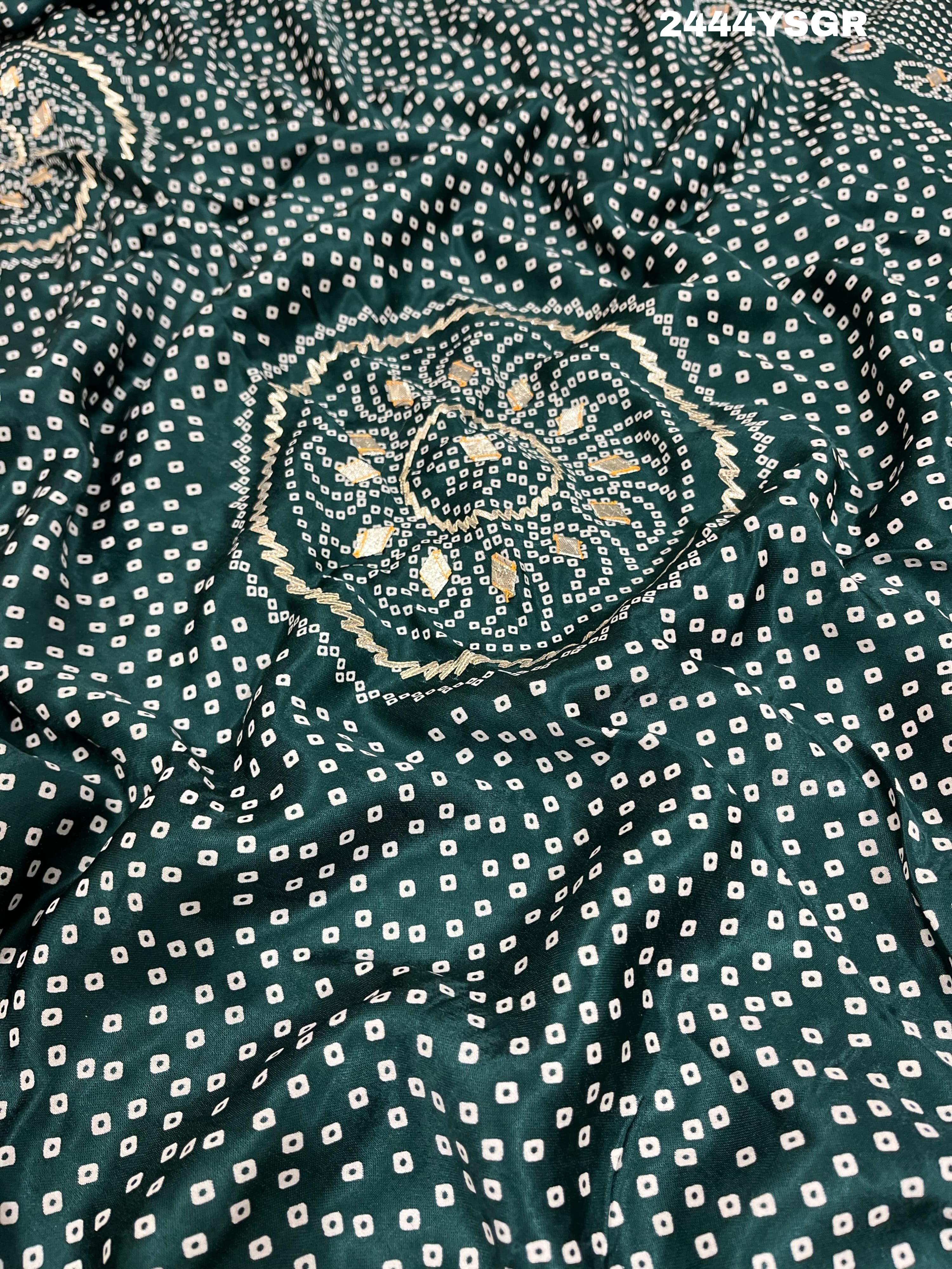 A green modal silk saree with bandhani style patterns and gotapatti work