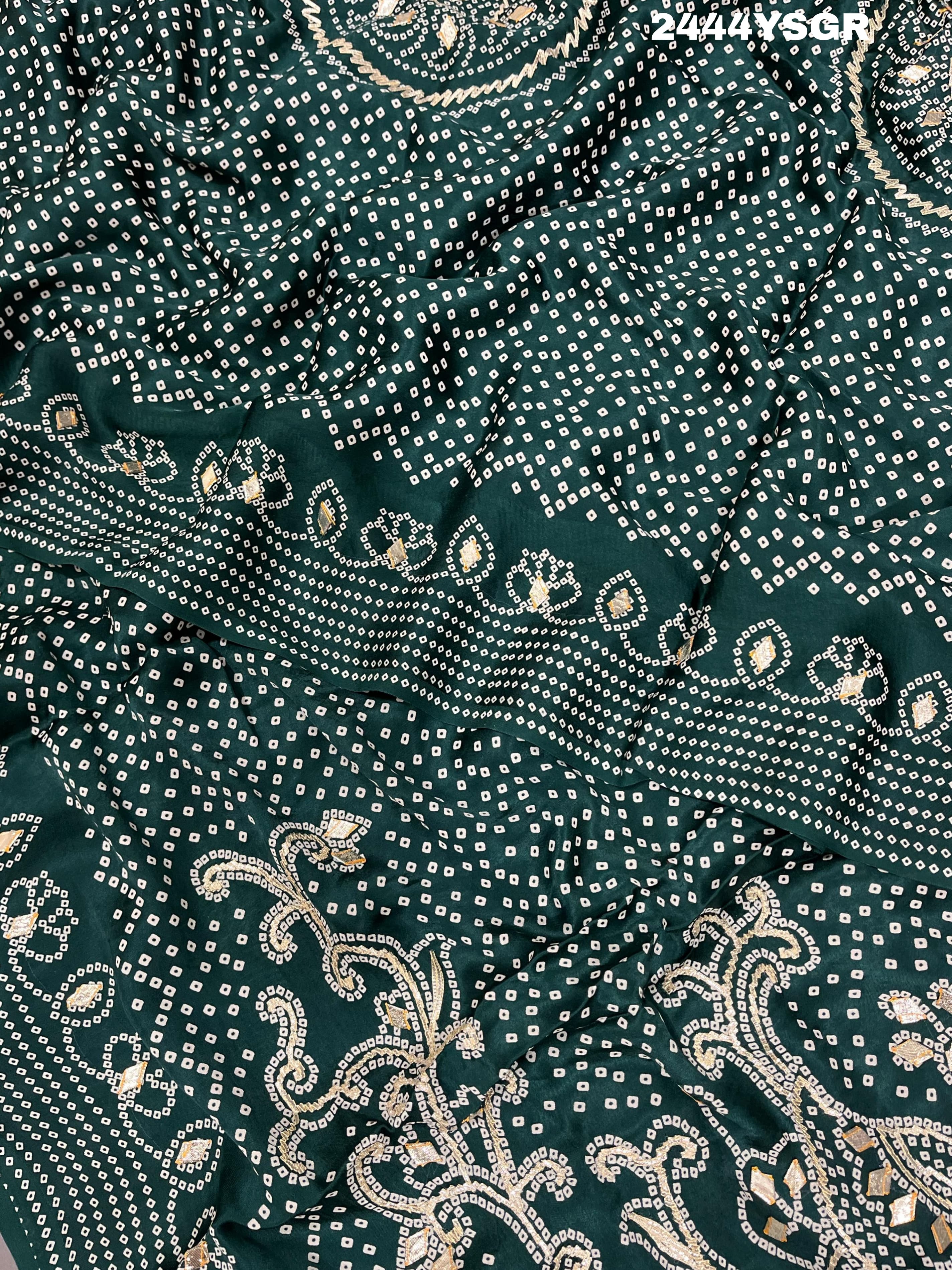 A green modal silk saree with bandhani style patterns and gotapatti work