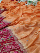 A Banarasi style saree with peach color and cutdana work, accompanied by a red and gold patterned border.