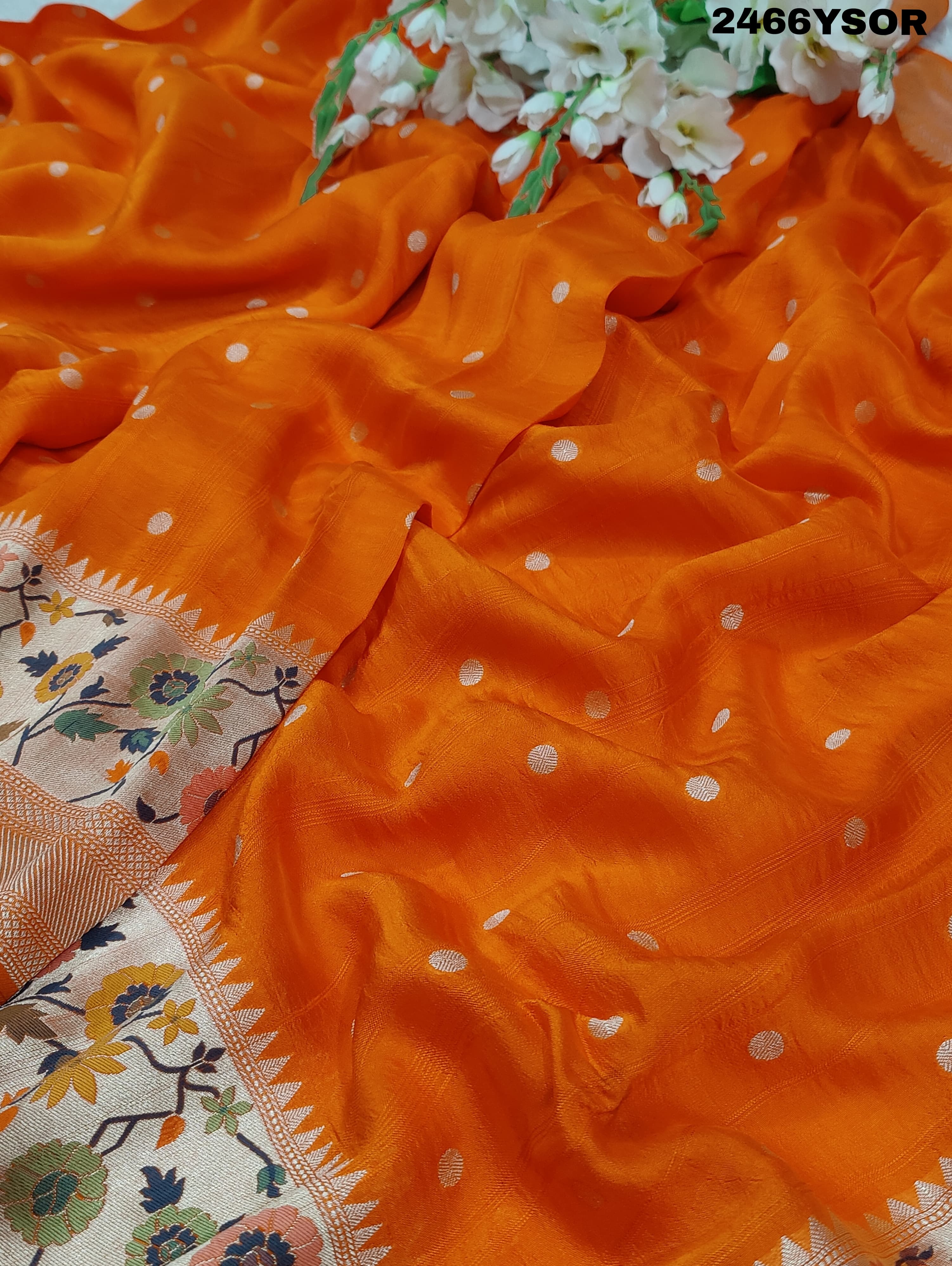 An orange Banarasi silk saree with floral printed style and zari weaving work