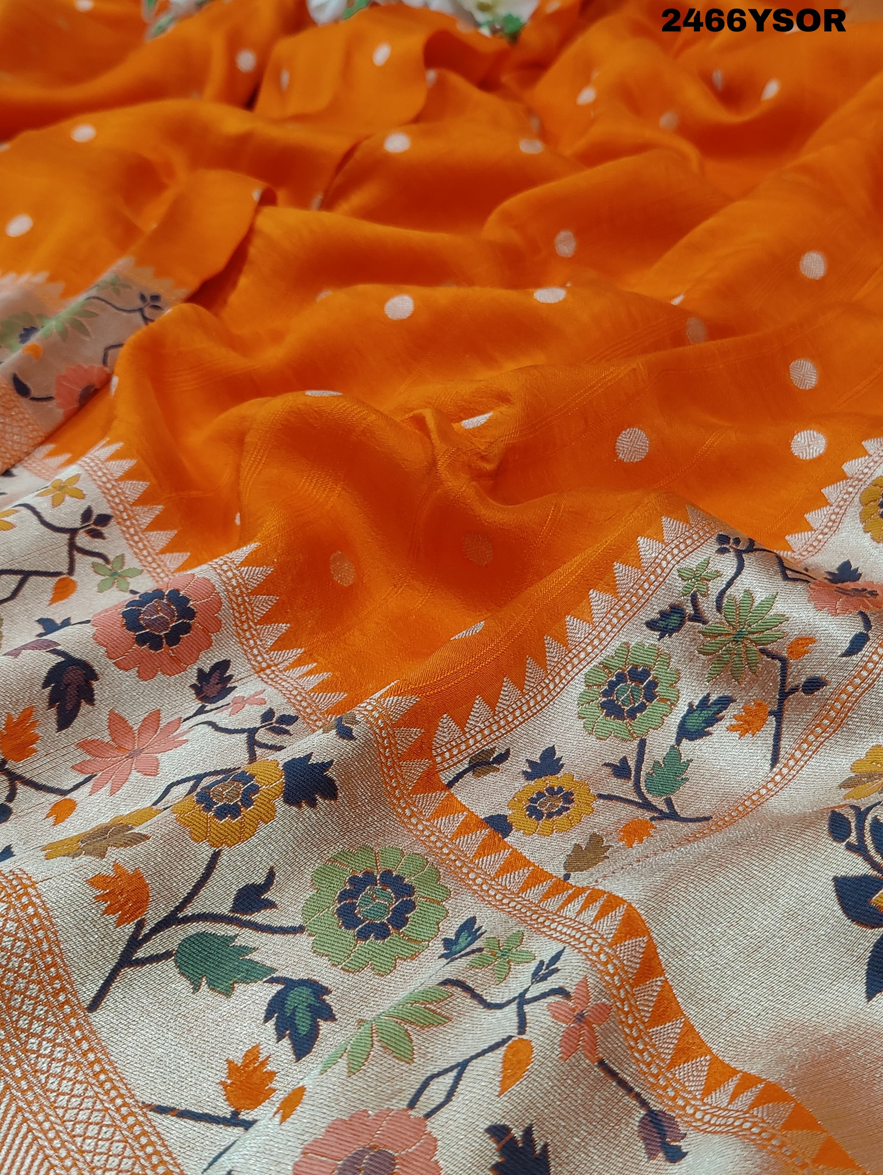 An orange Banarasi silk saree with floral printed style and zari weaving work