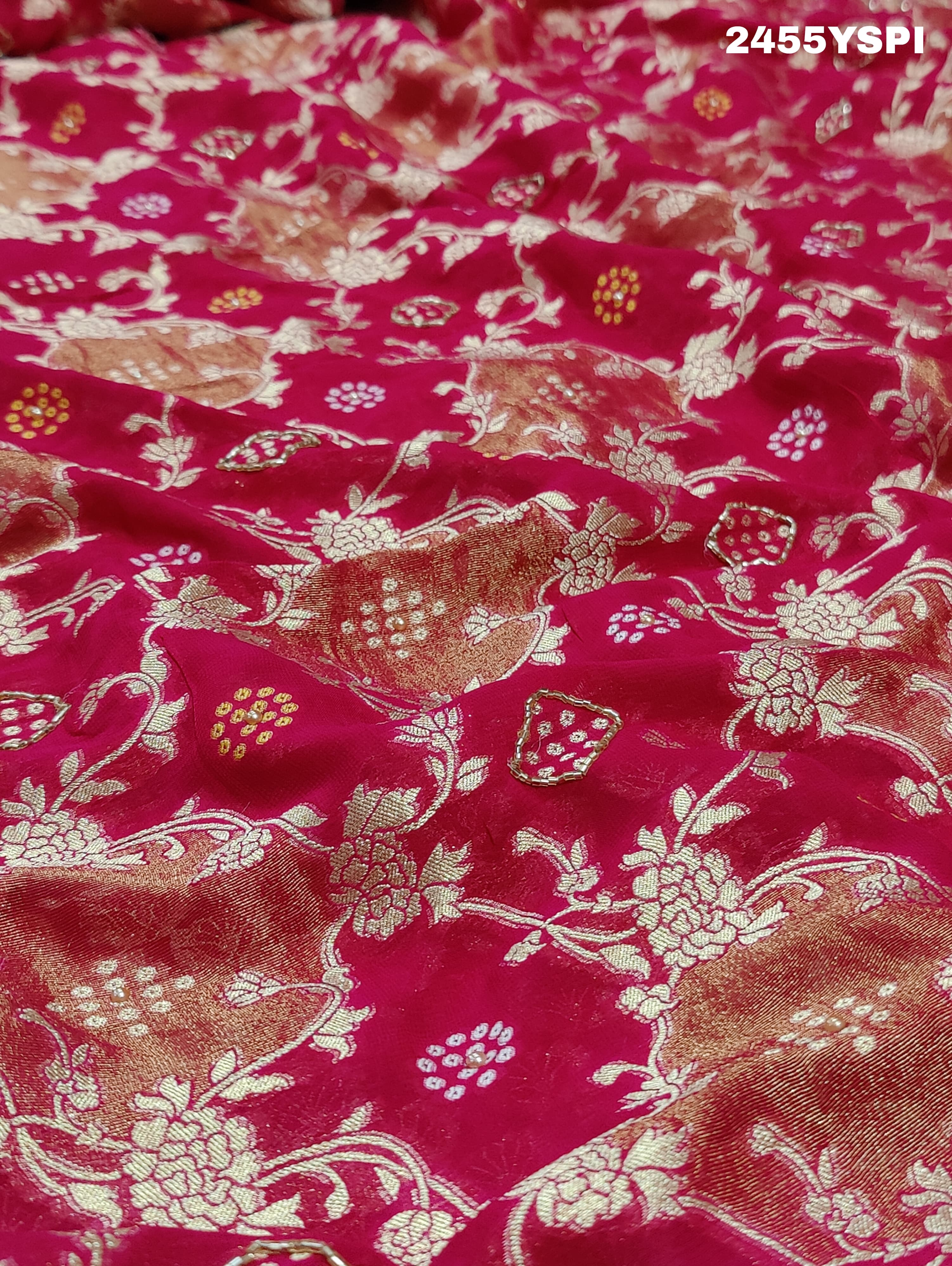 A Banarasi style saree with cutdana work, predominantly pink with gold geometric patterns