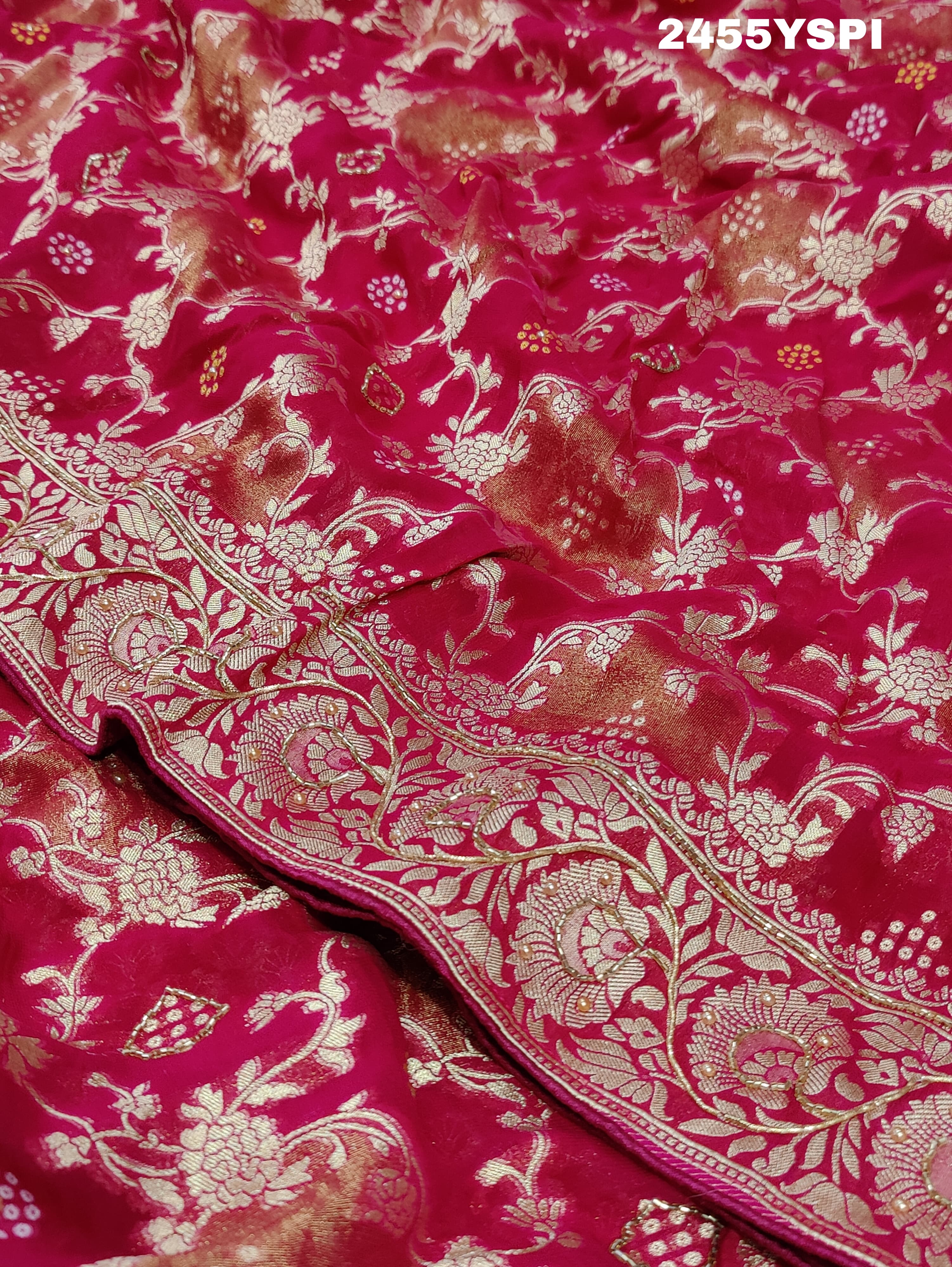 A Banarasi style saree with cutdana work, predominantly pink with gold geometric patterns