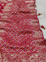 A Banarasi style saree with cutdana work, predominantly pink with gold geometric patterns