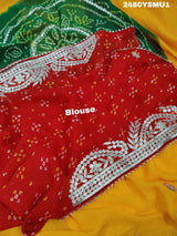 A saree with bandhani style patterns in orange and red colors, featuring detailed gotapatti work.
