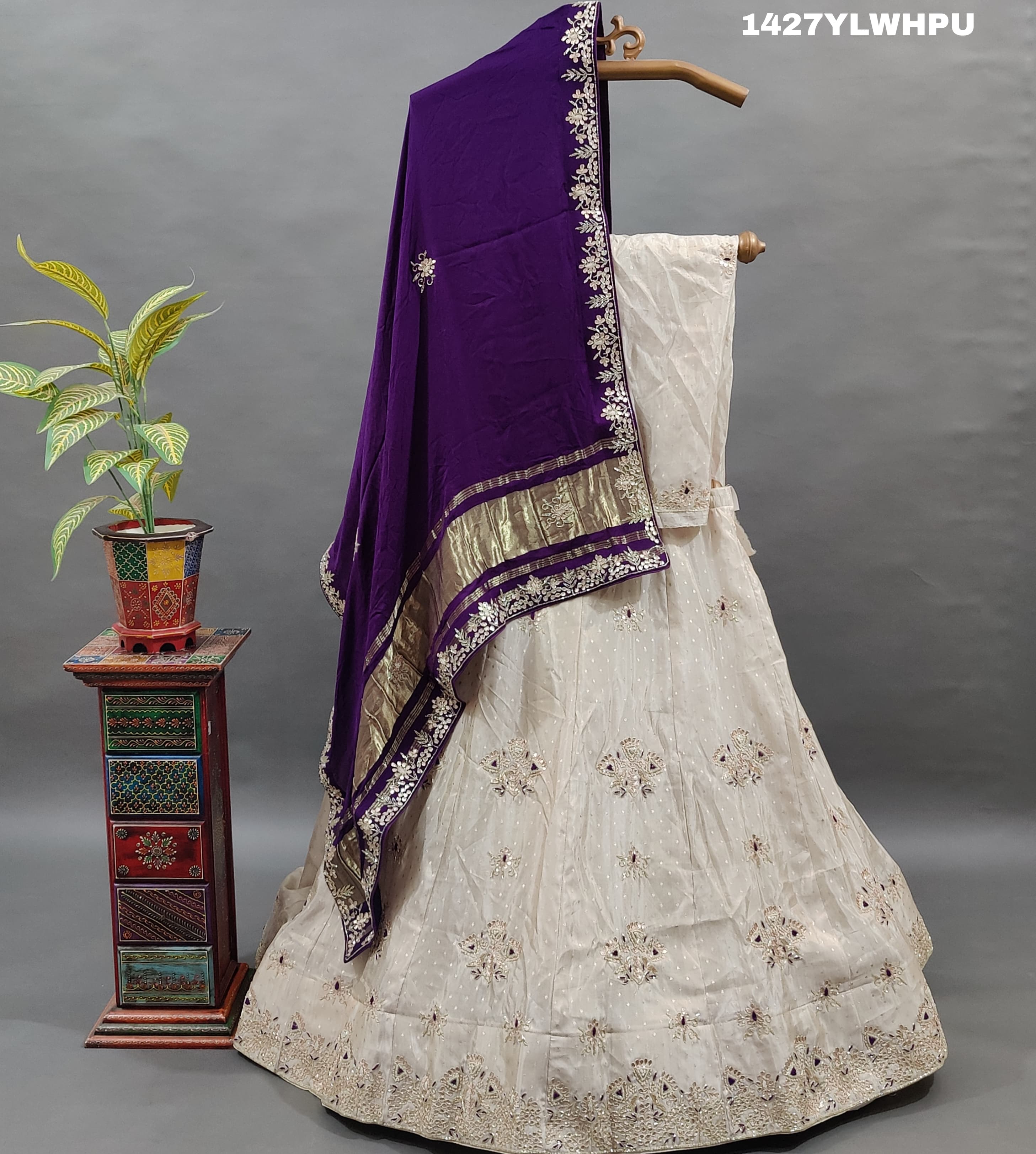 A traditional white lehenga Zardoji Gotapatti embroidery