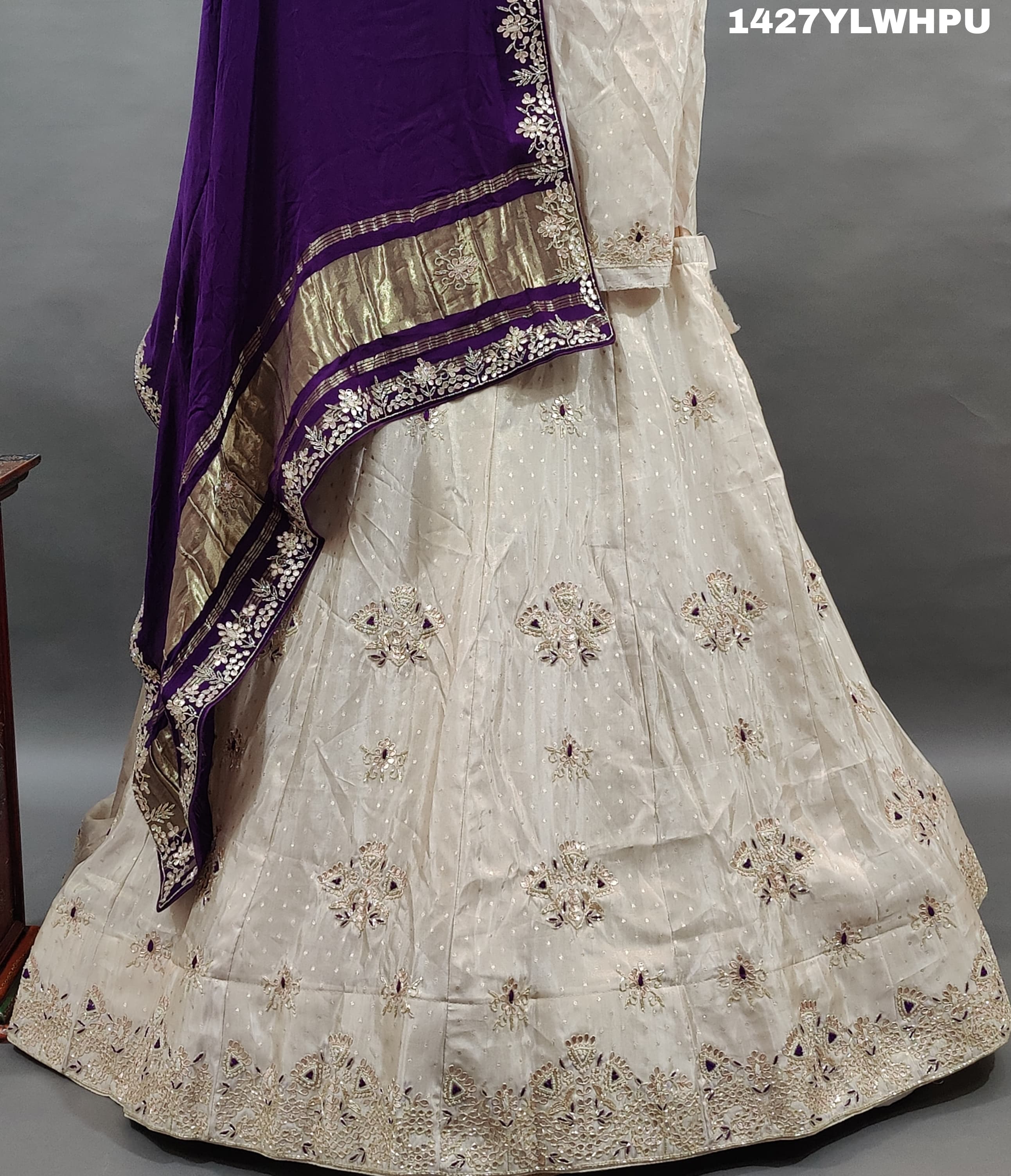A traditional white lehenga Zardoji Gotapatti embroidery