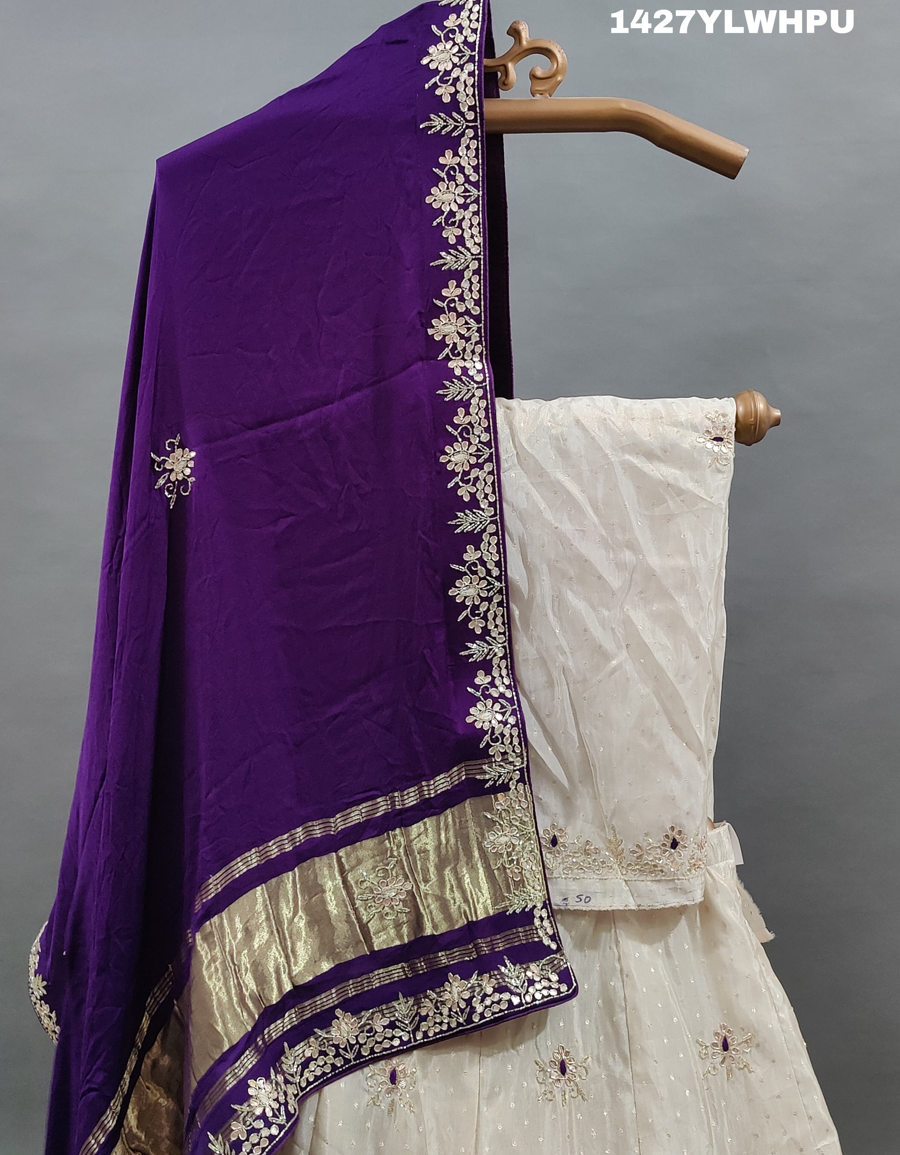 A traditional white lehenga Zardoji Gotapatti embroidery