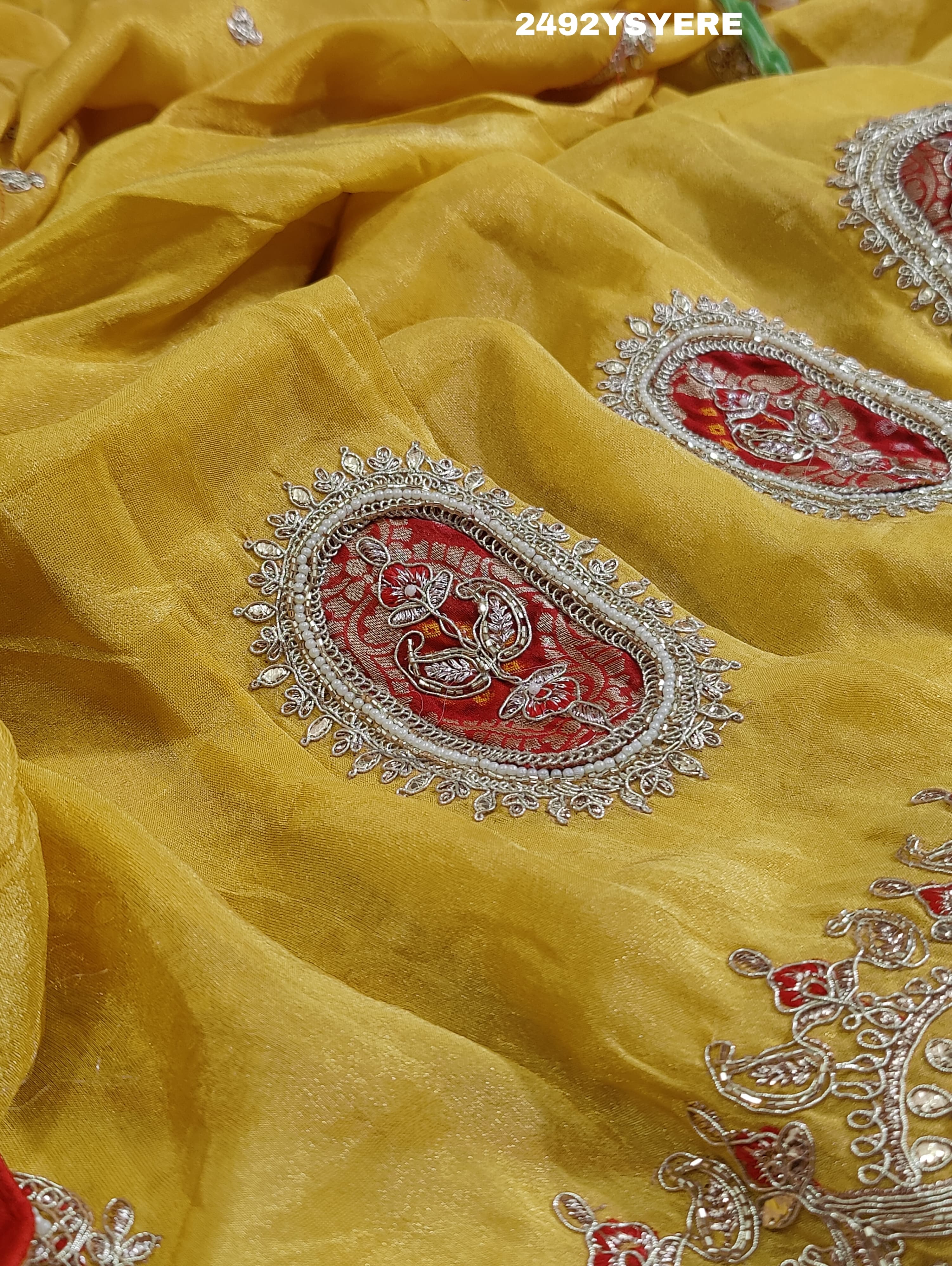 A Banarasi silk saree with sequence embroidery work, featuring a design in yellow and red patterns