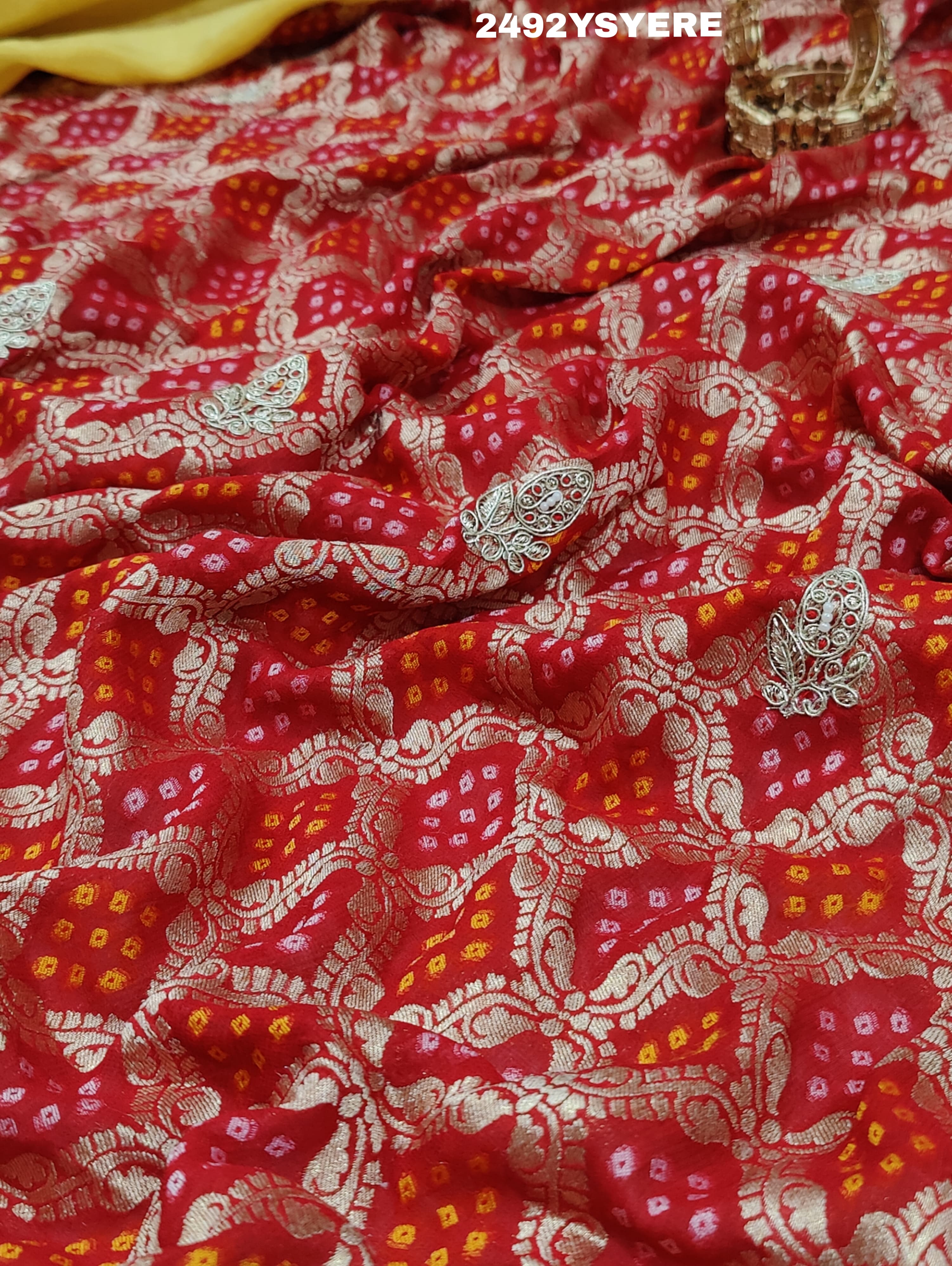 A Banarasi silk saree with sequence embroidery work, featuring a design in yellow and red patterns