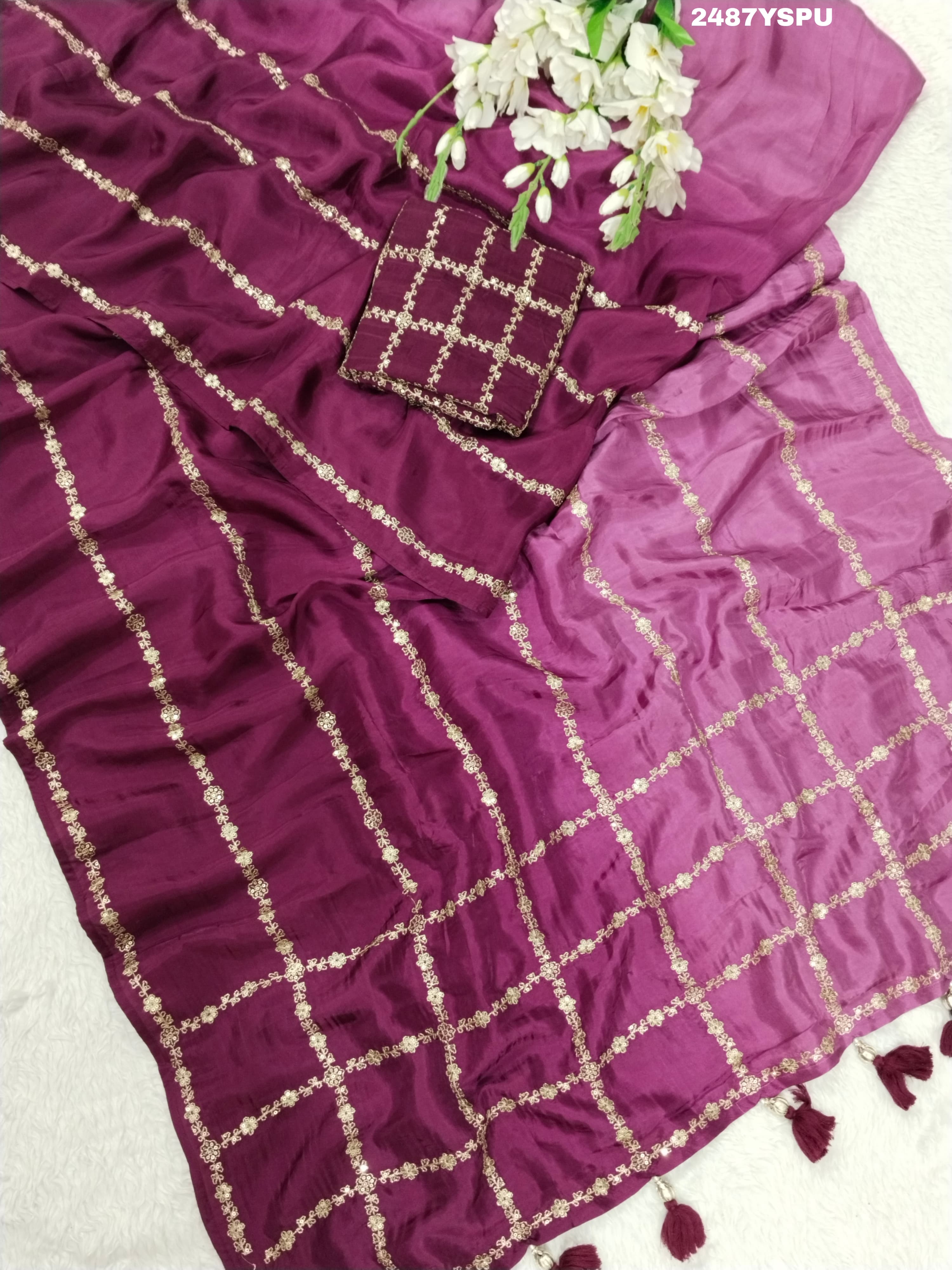 A purple Bollywood style silk saree with geometric pattern and pittan work