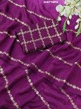 A purple Bollywood style silk saree with geometric pattern and pittan work