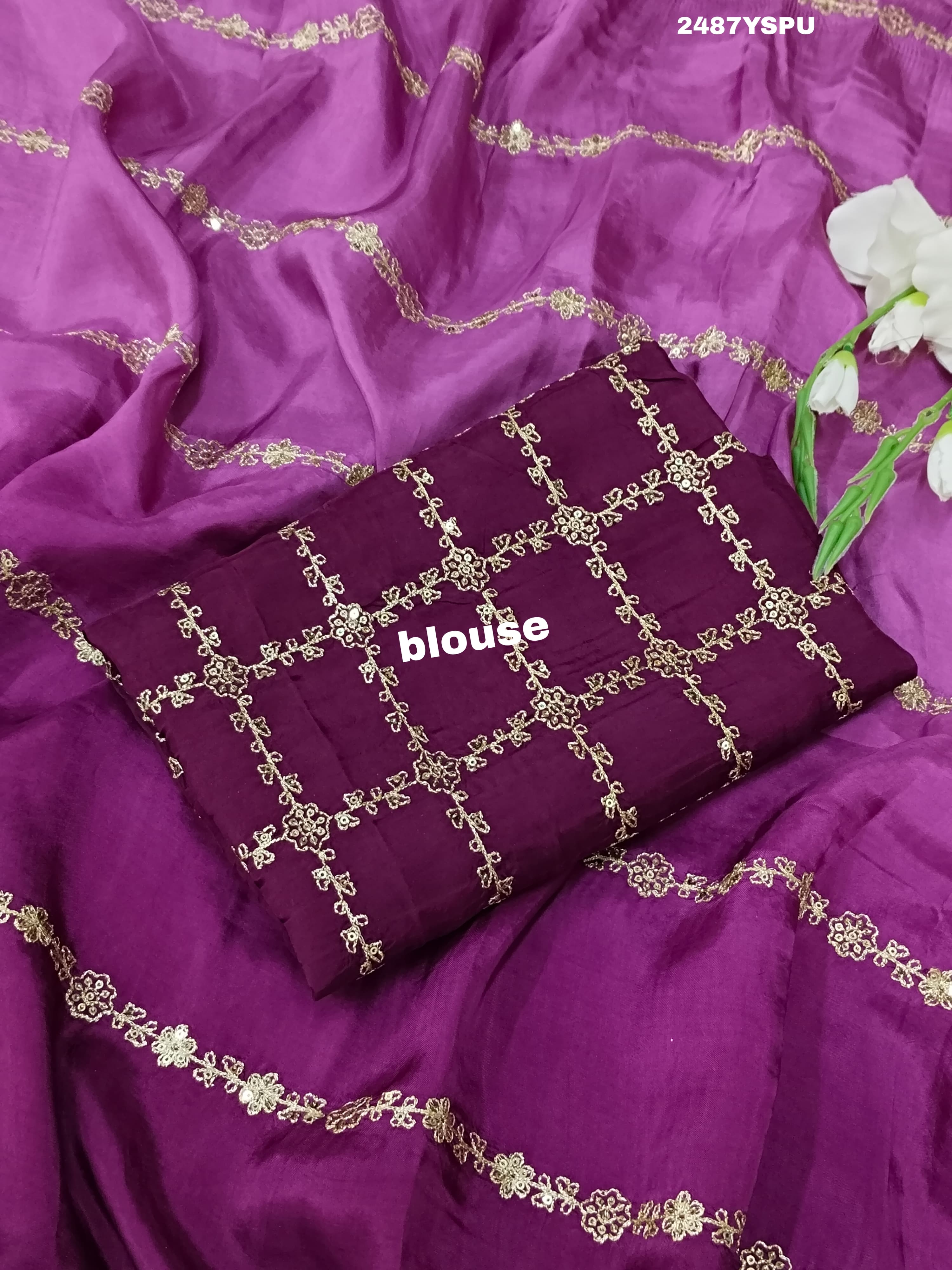 A purple Bollywood style silk saree with geometric pattern and pittan work