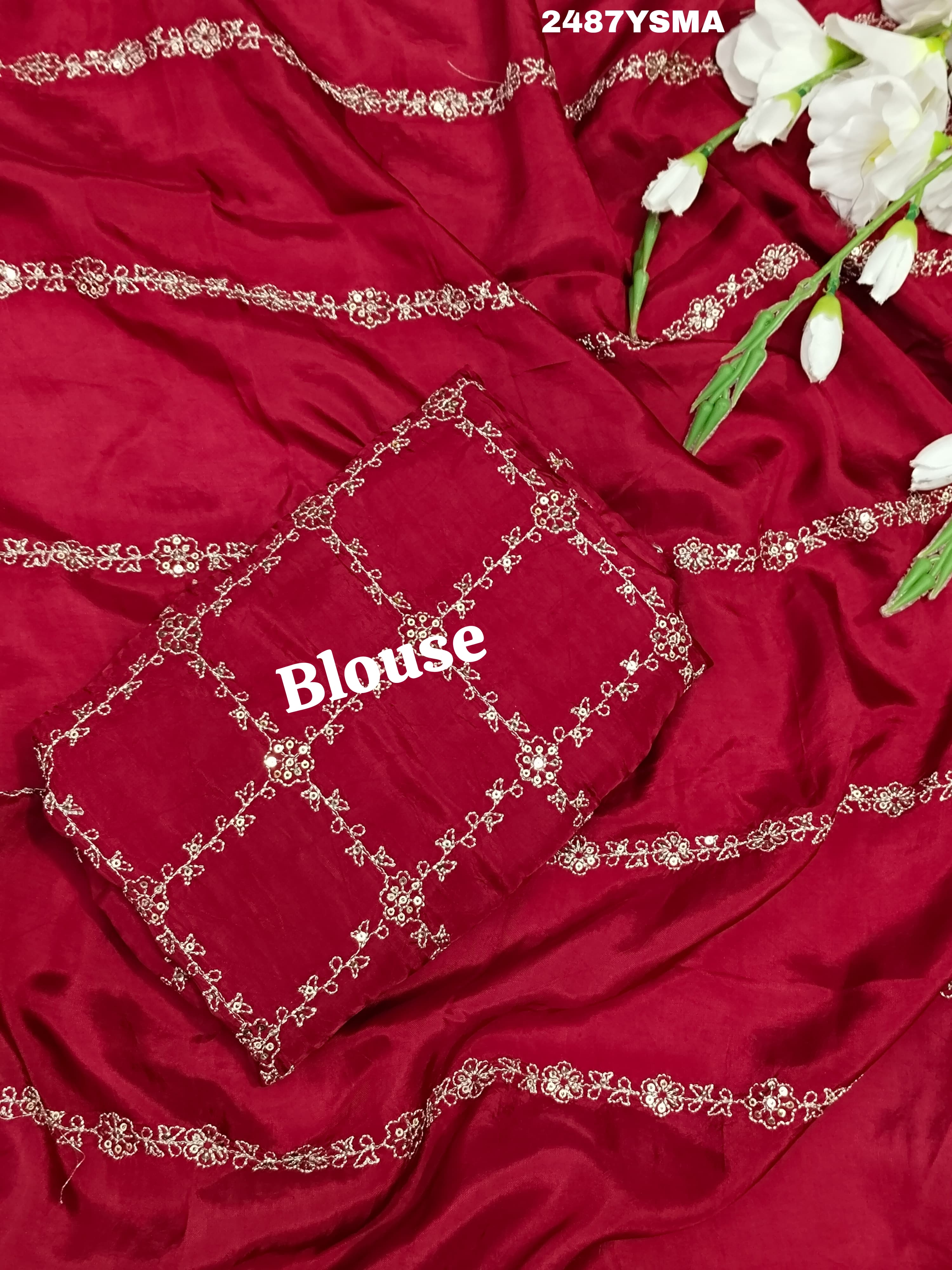 A maroon saree with geometric pattern and pittan work