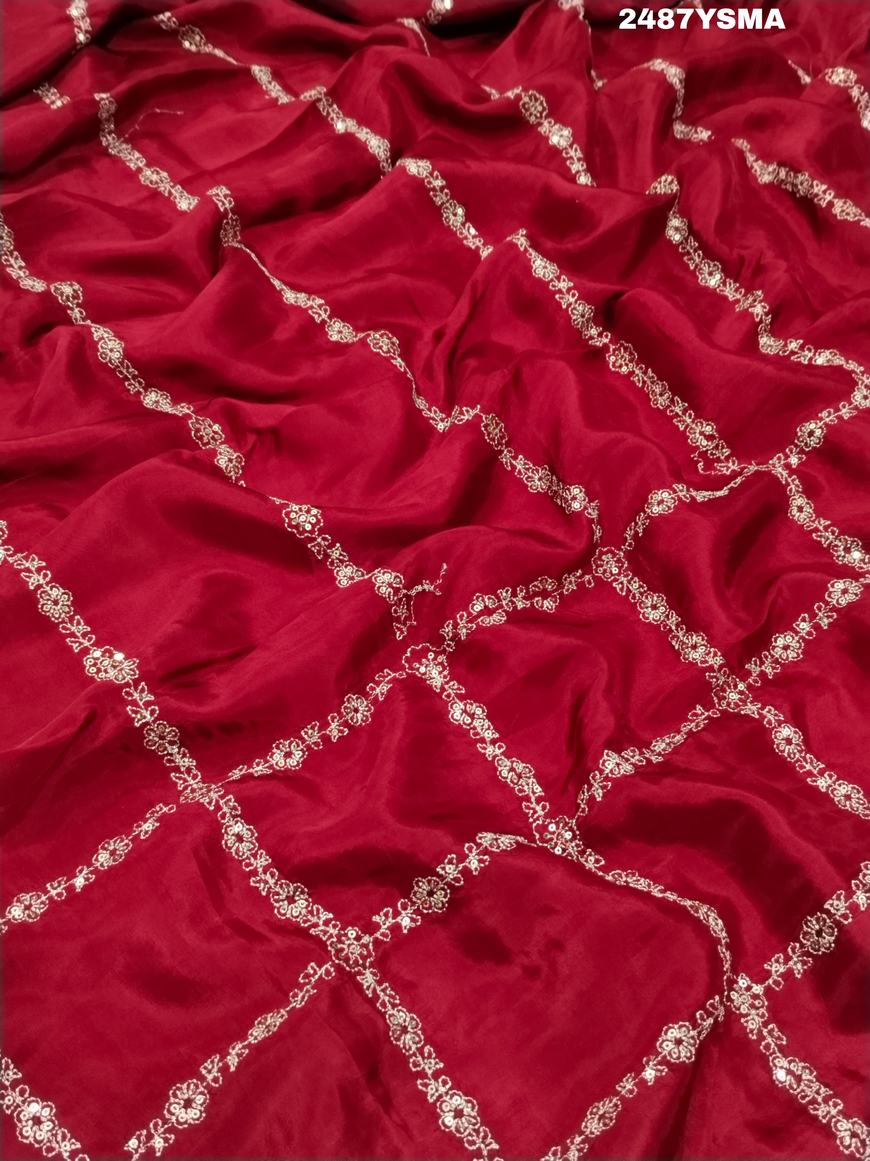 A maroon saree with geometric pattern and pittan work