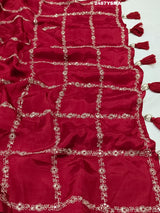 A maroon saree with geometric pattern and pittan work
