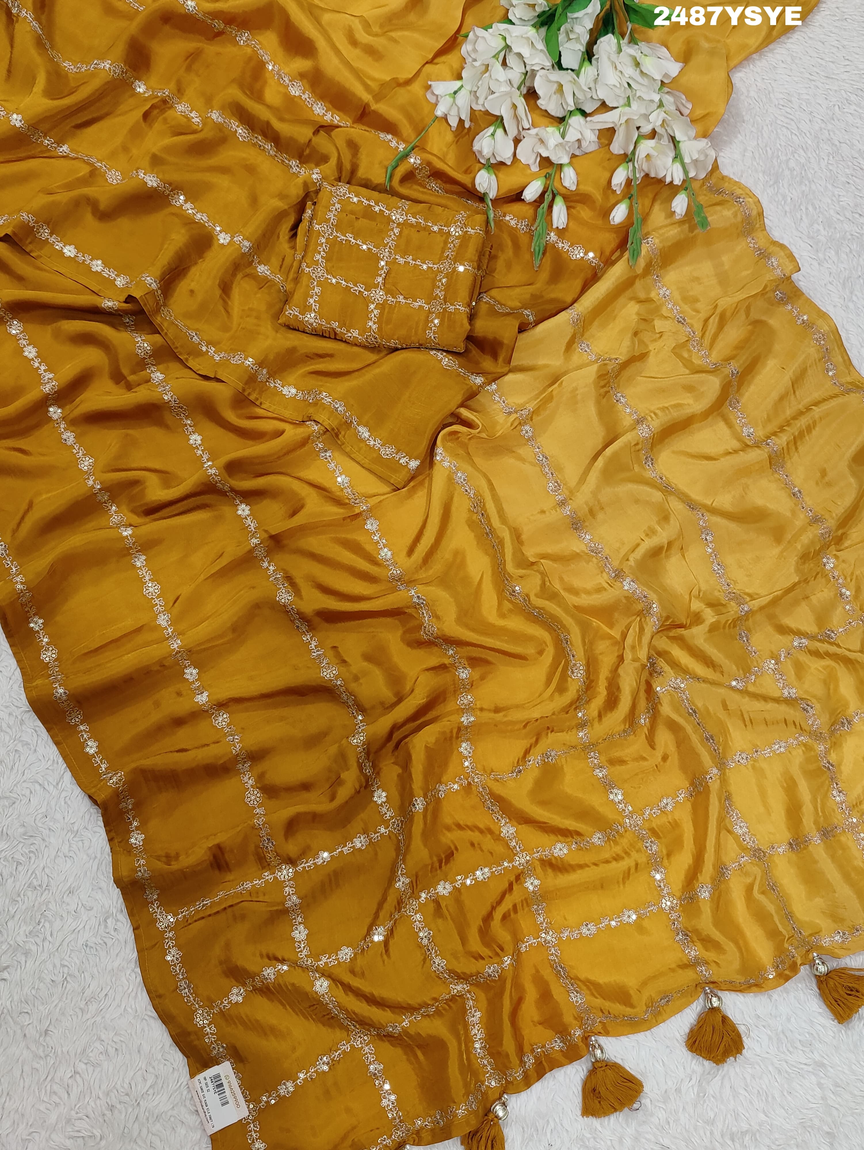 A yellow saree with floral pitton work