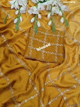 A yellow saree with floral pitton work