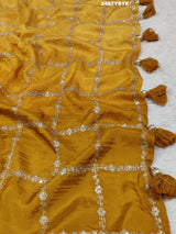 A yellow saree with floral pitton work