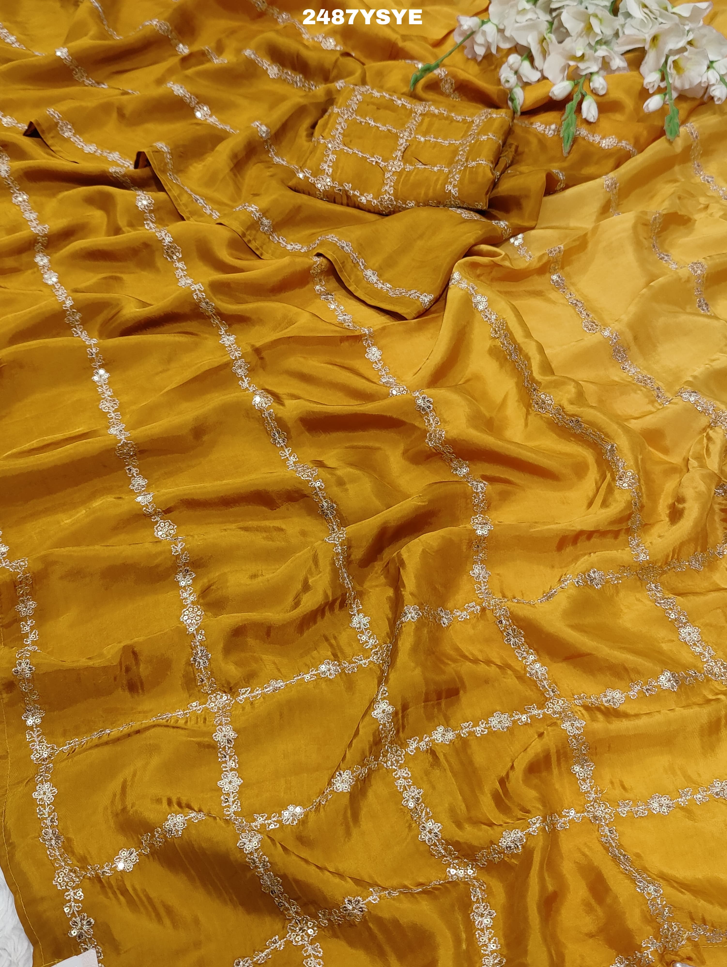 A yellow saree with floral pitton work