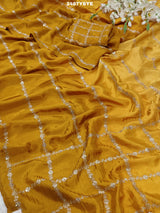 A yellow saree with floral pitton work