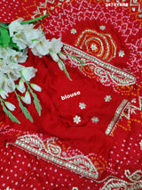 A red Gaji silk saree with Bandhani style embellishments and Gotapatti work