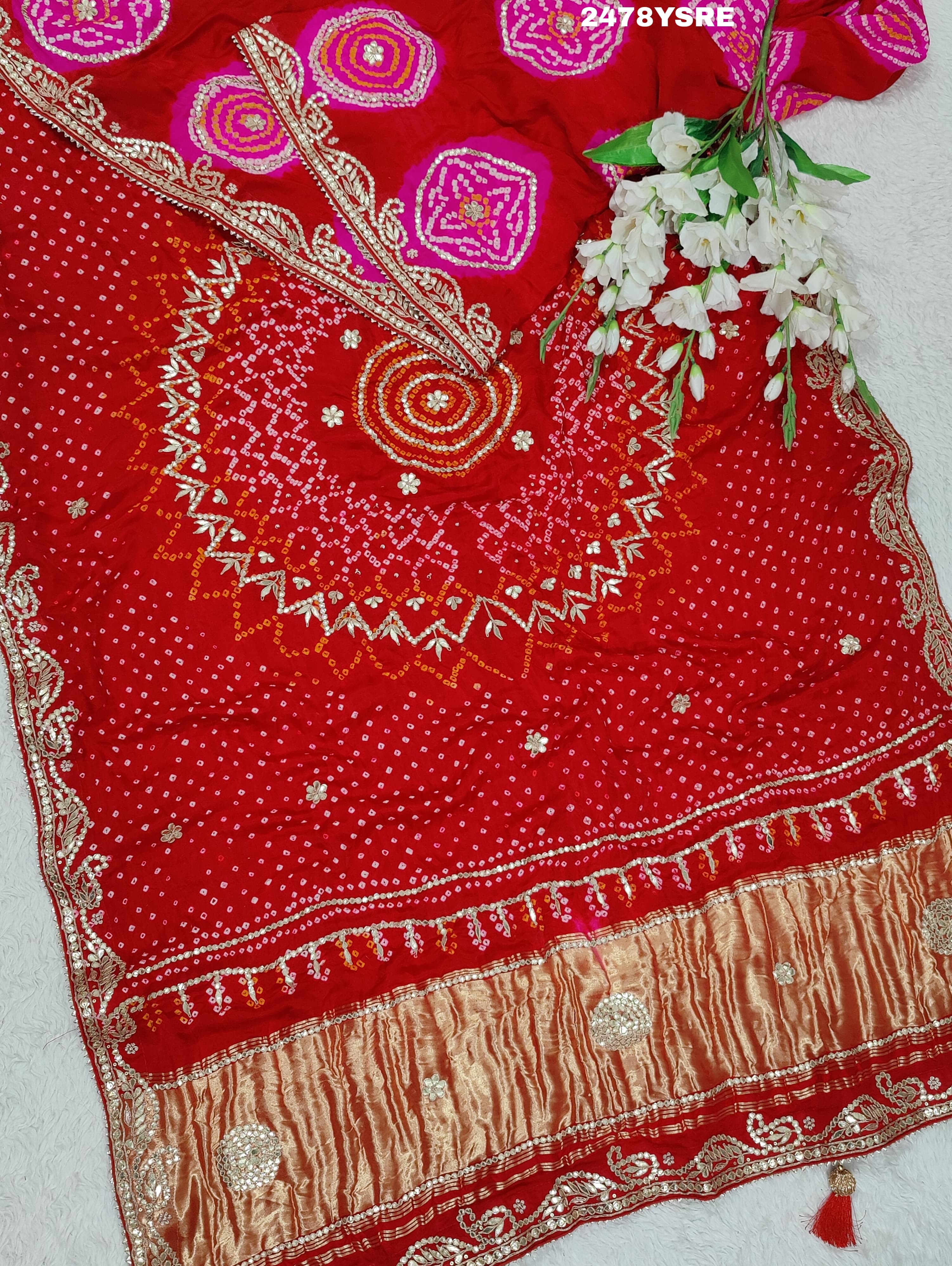 A red Gaji silk saree with Bandhani style embellishments and Gotapatti work