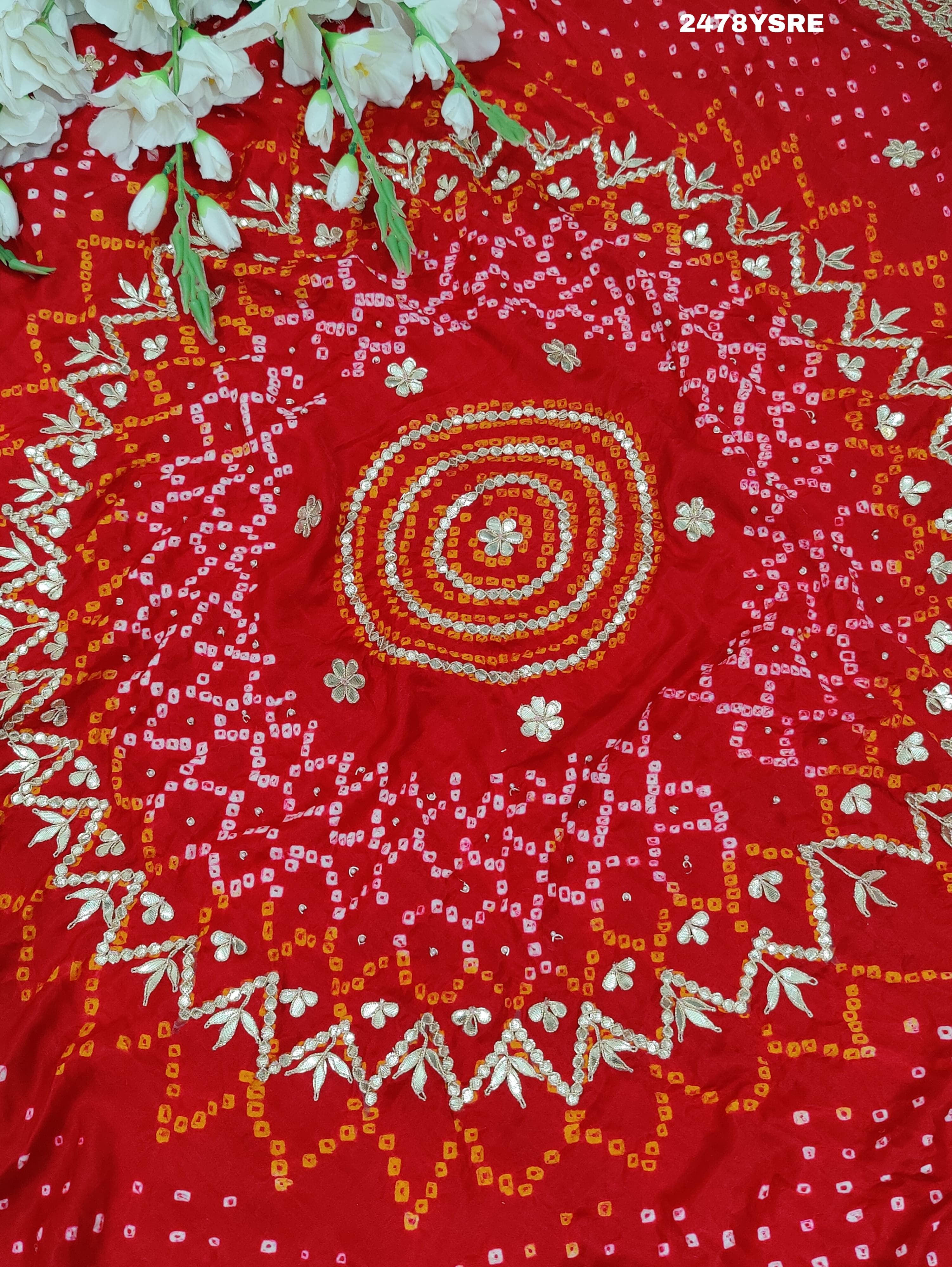 A red Gaji silk saree with Bandhani style embellishments and Gotapatti work