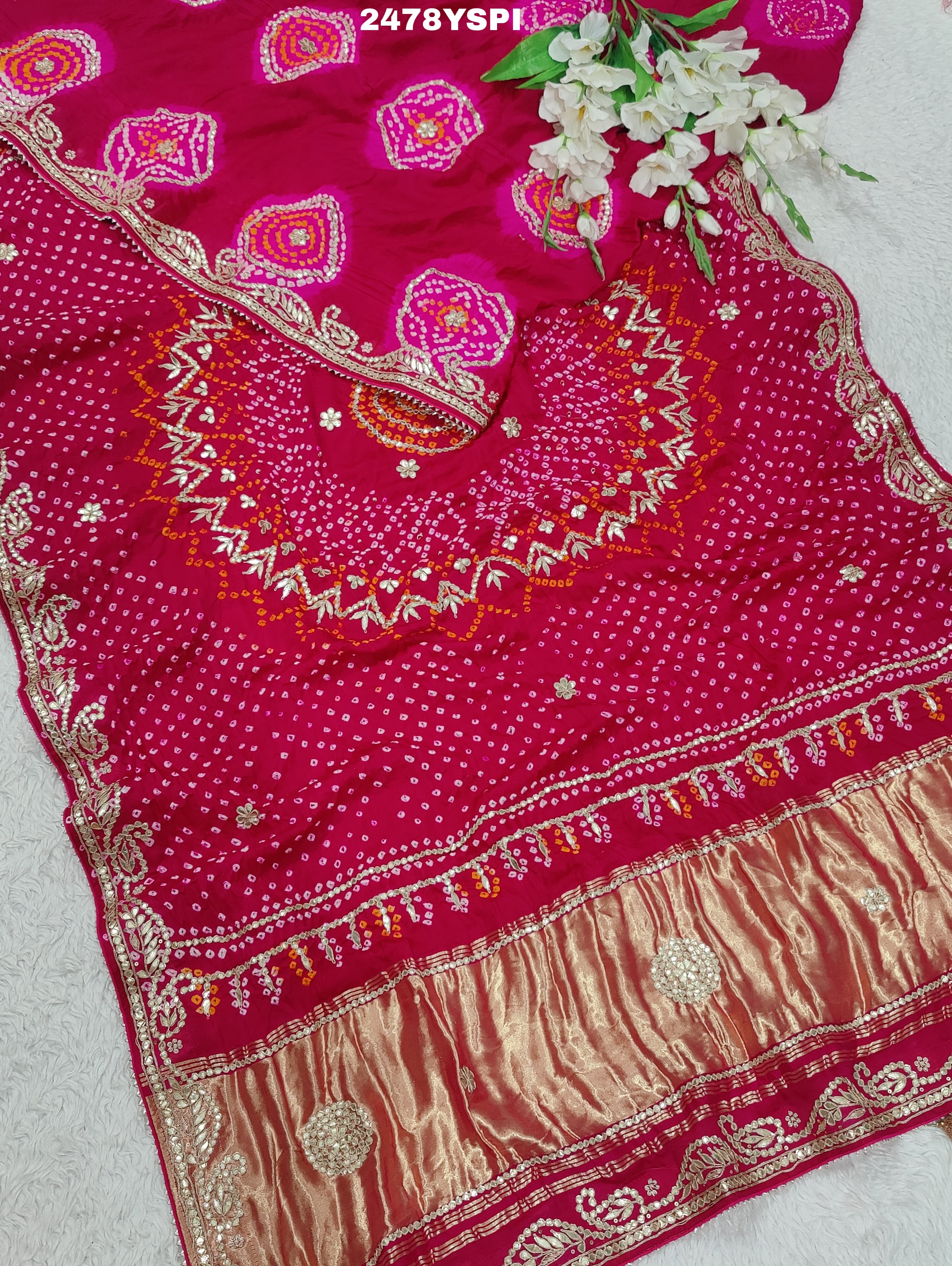 A pink Gaji silk saree with Bandhani style embellishments and Gotapatti work