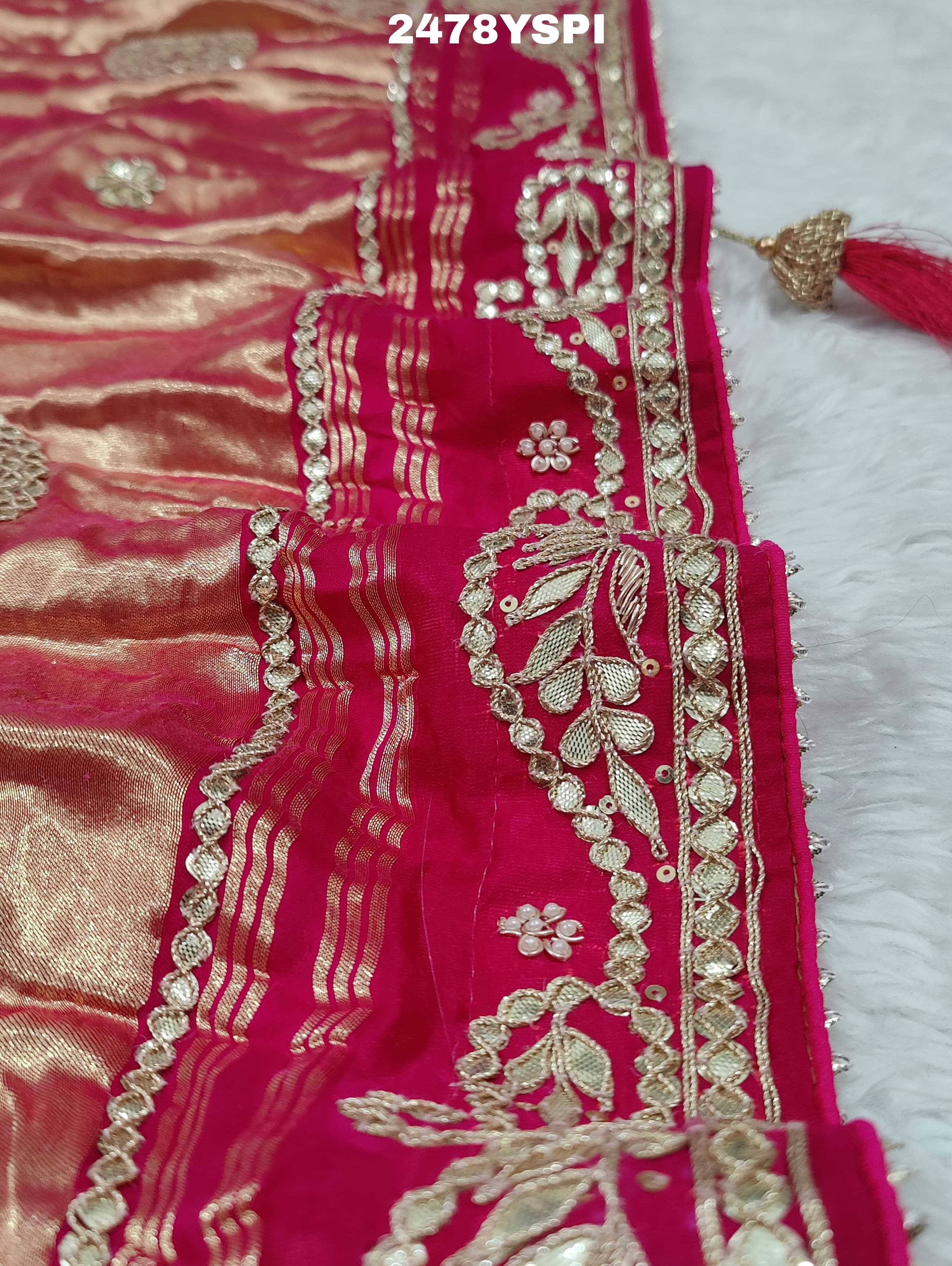 A pink Gaji silk saree with Bandhani style embellishments and Gotapatti work