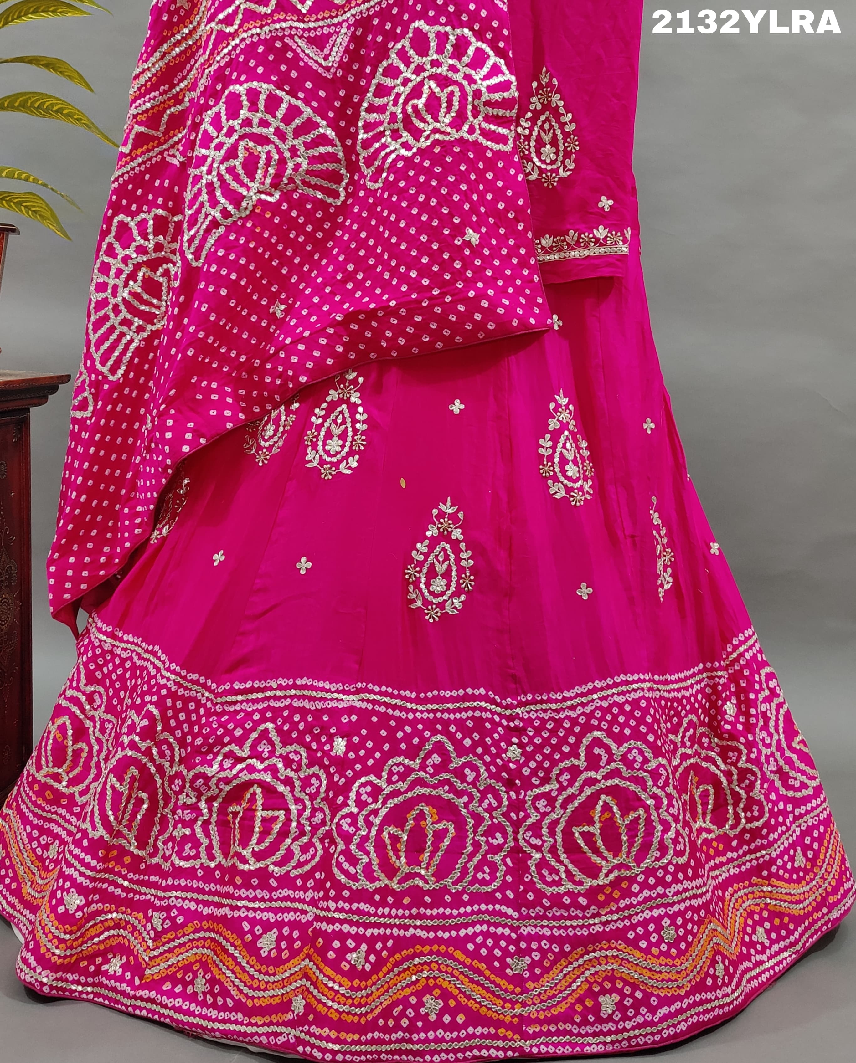 A traditional pink lehanga with bandhani style and gotapatti work