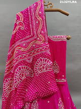 A traditional pink lehanga with bandhani style and gotapatti work