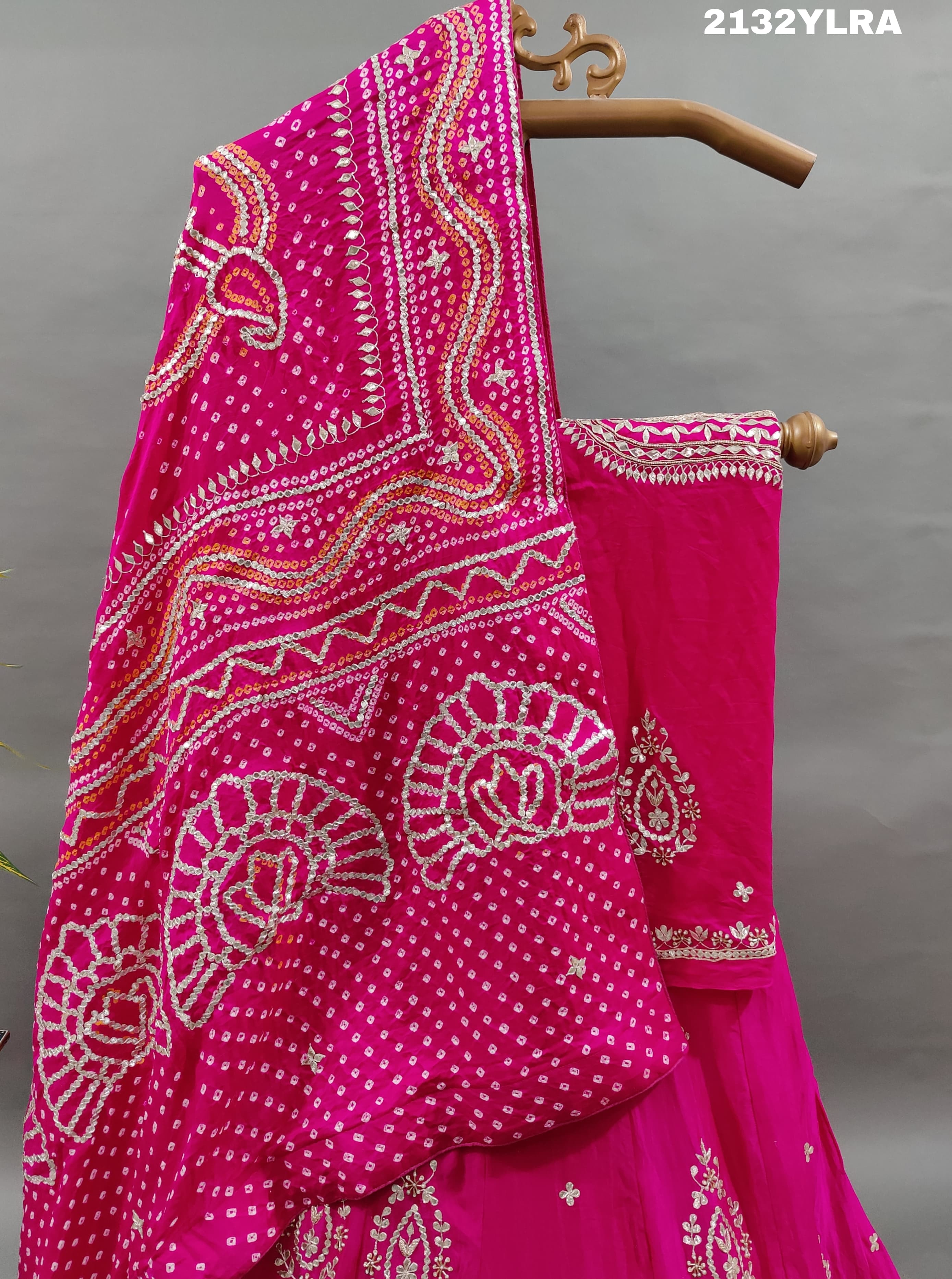 A traditional pink lehanga with bandhani style and gotapatti work