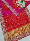 A pink and red Gaji silk saree with Bandhani style Gotapatti work.