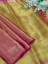 A Banarasi style tissue silk saree with zari border work yellow and pink color