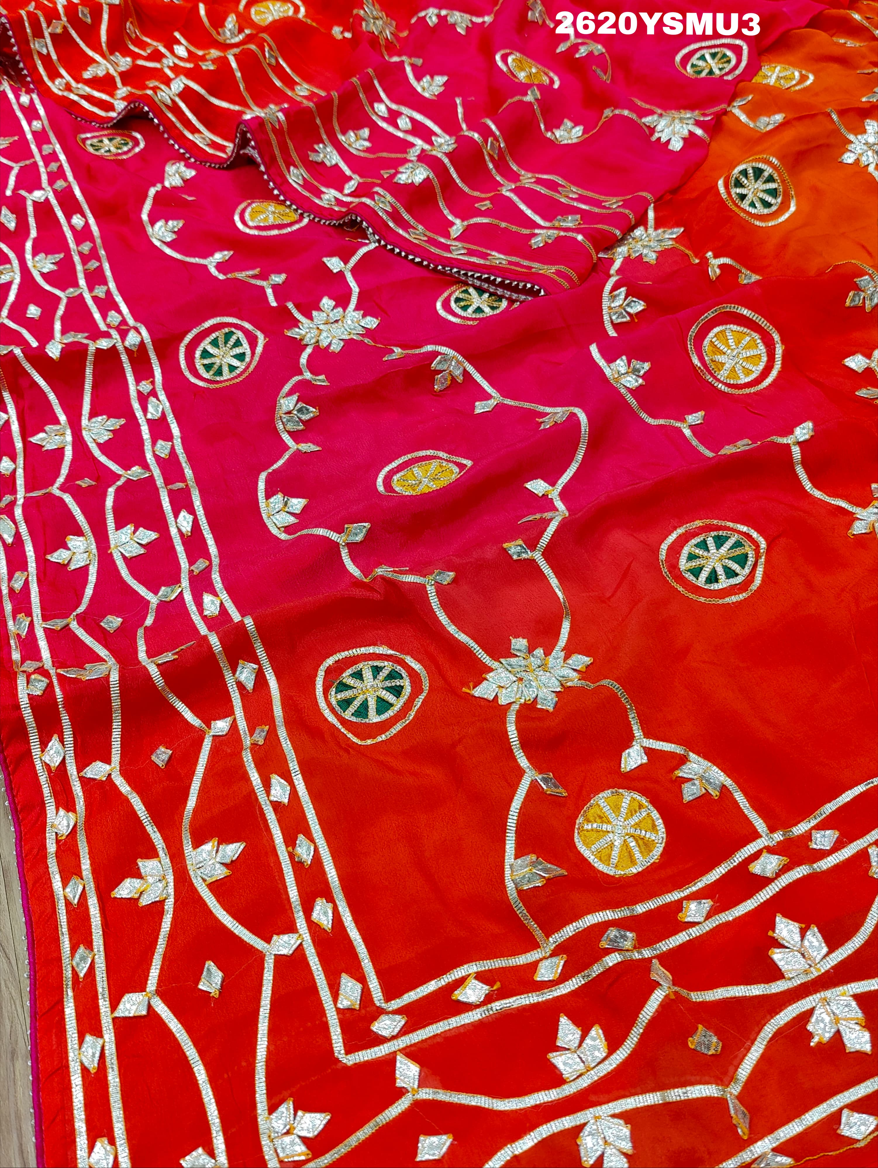 Red and orange saree with white floral patternsBollywood Style with Gotapatti Work