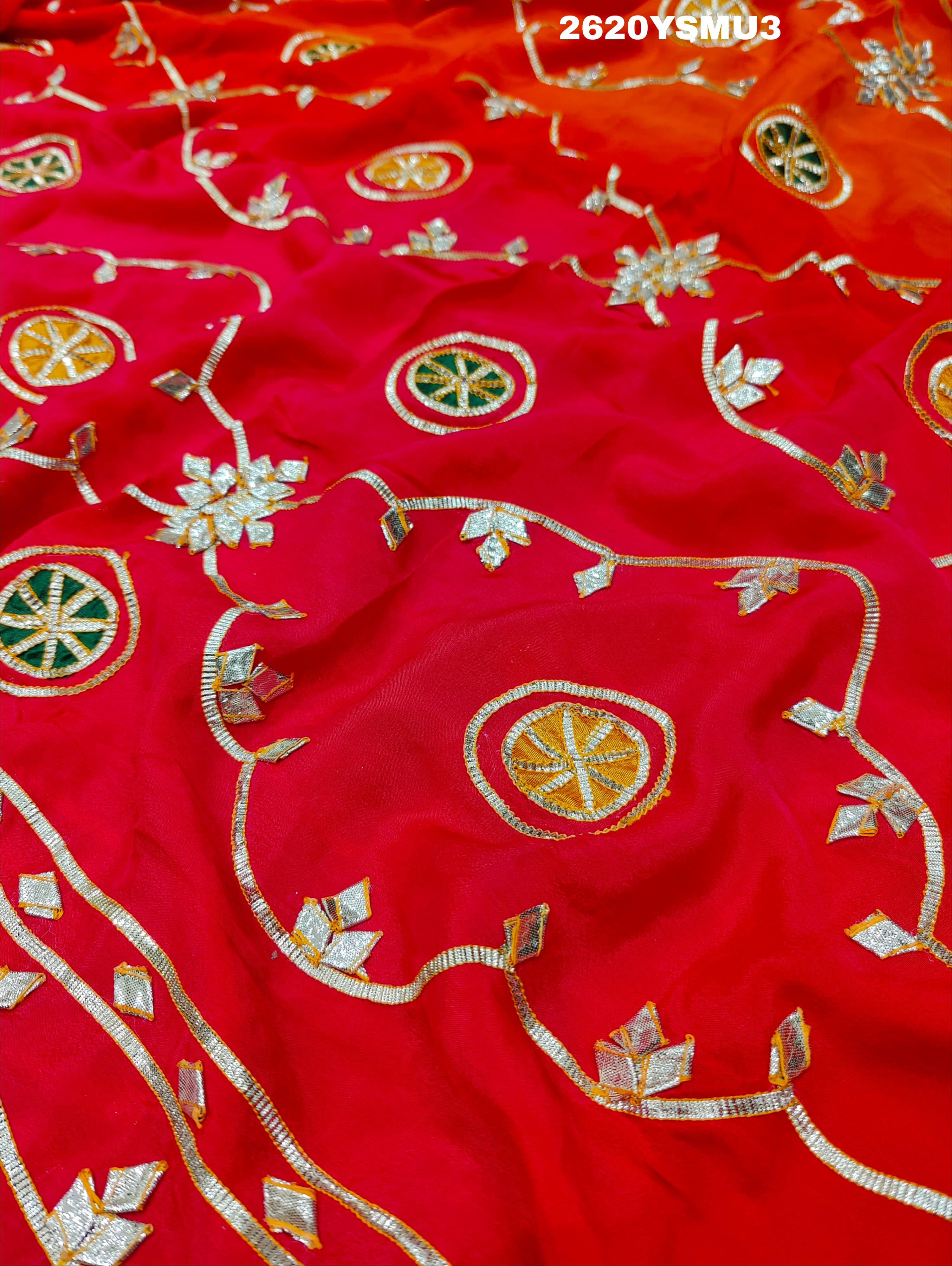 Red and orange saree with white floral patternsBollywood Style with Gotapatti Work